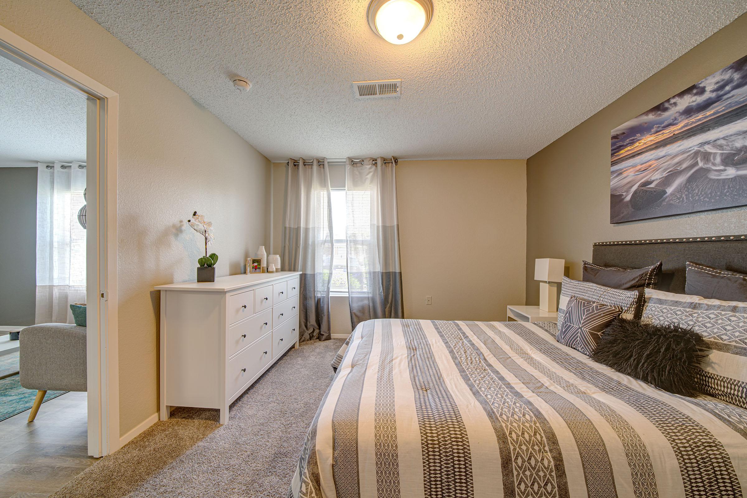 a bedroom with a large bed in a hotel room