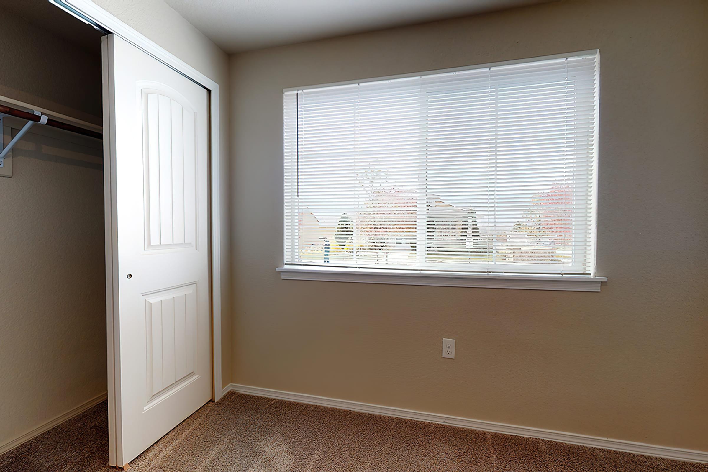 a bedroom with a large window