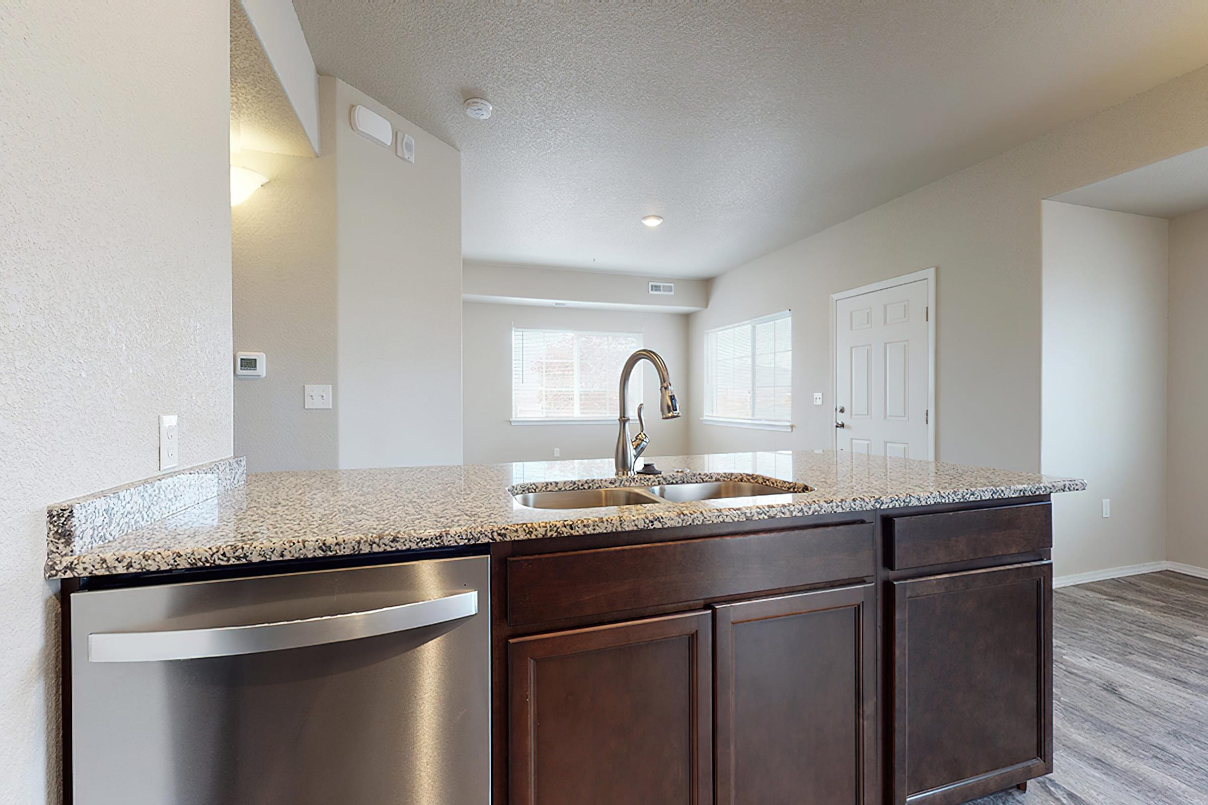 a kitchen with a sink and a mirror