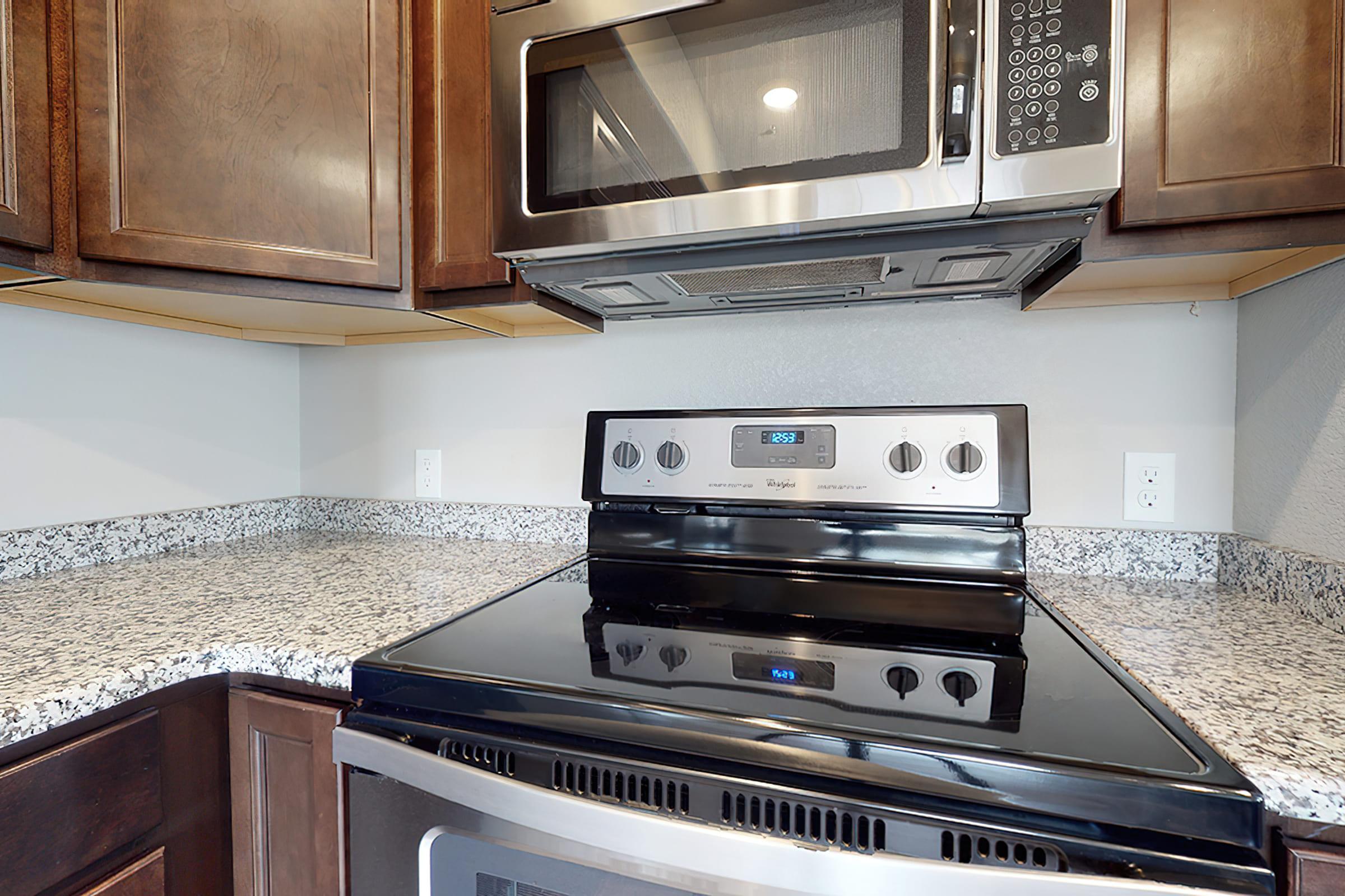 a kitchen with a stove a microwave oven sitting on top of a counter