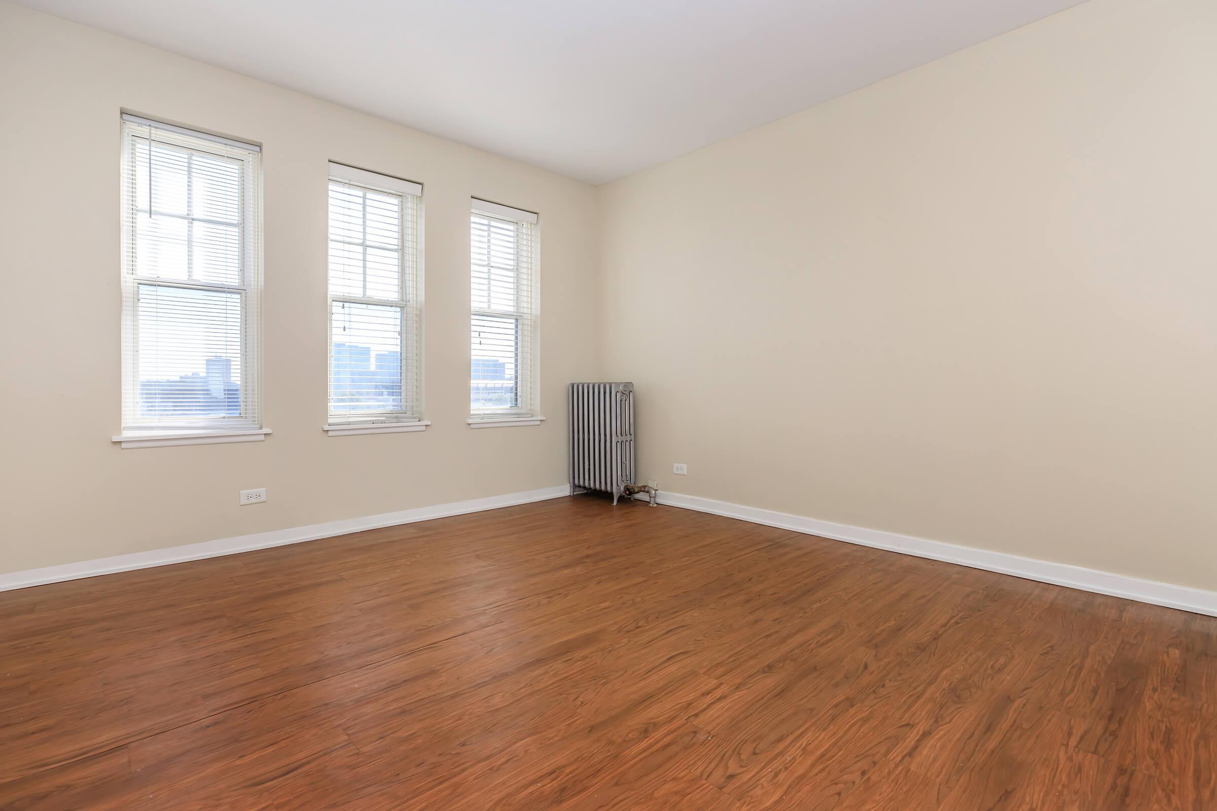 a large empty room with a wood floor