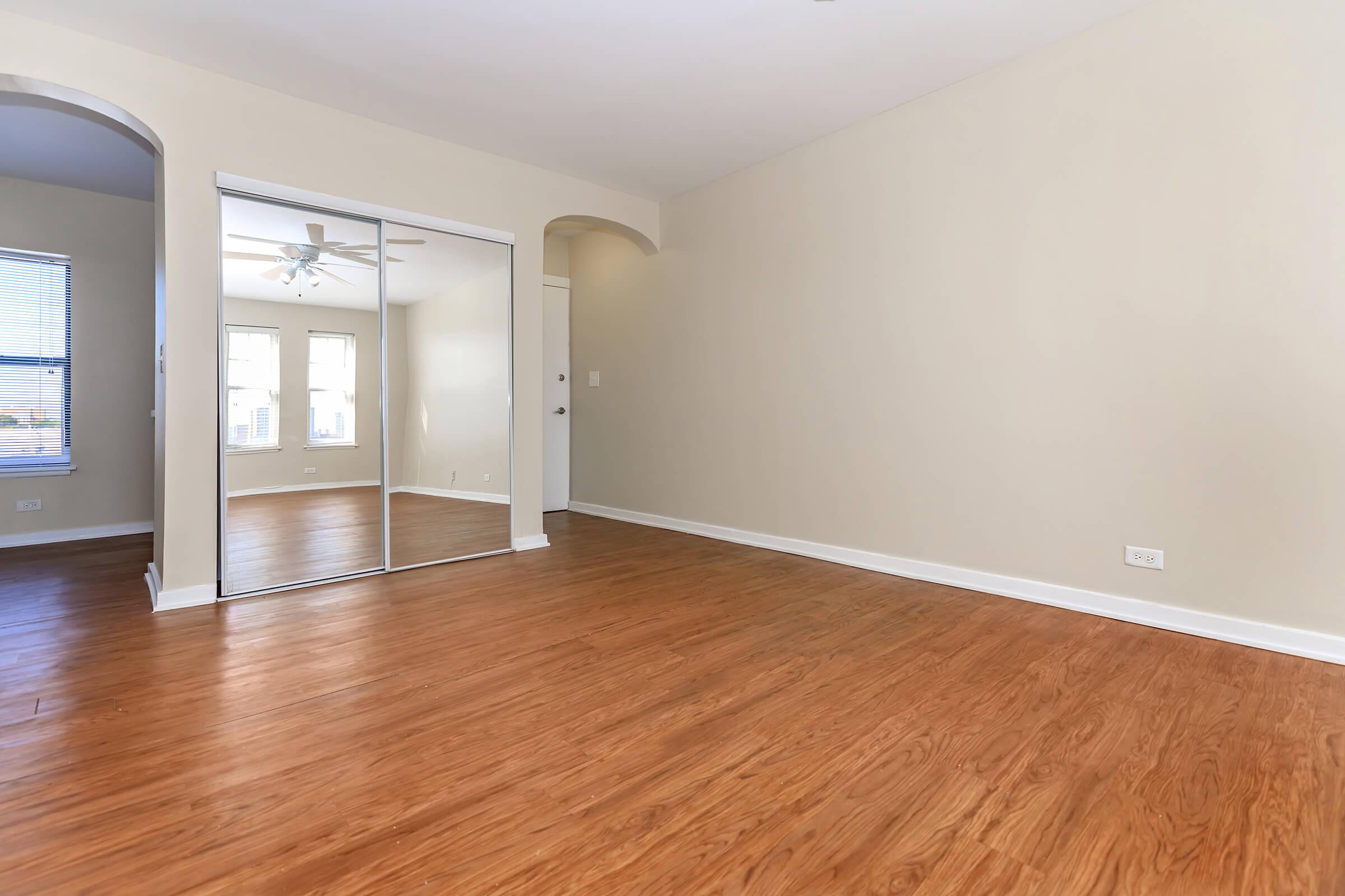 a large empty room with a wood floor