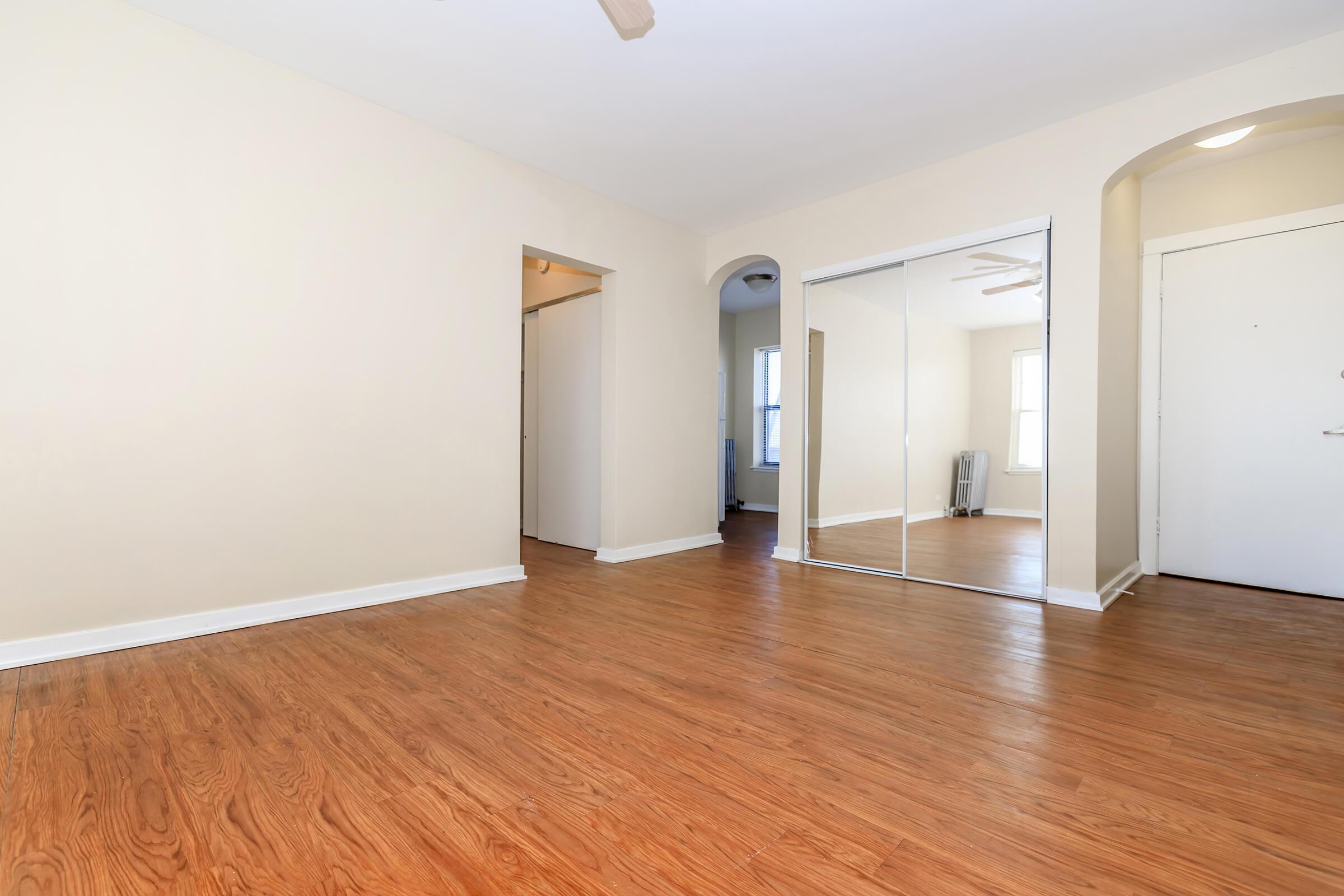 a large empty room with a wood floor