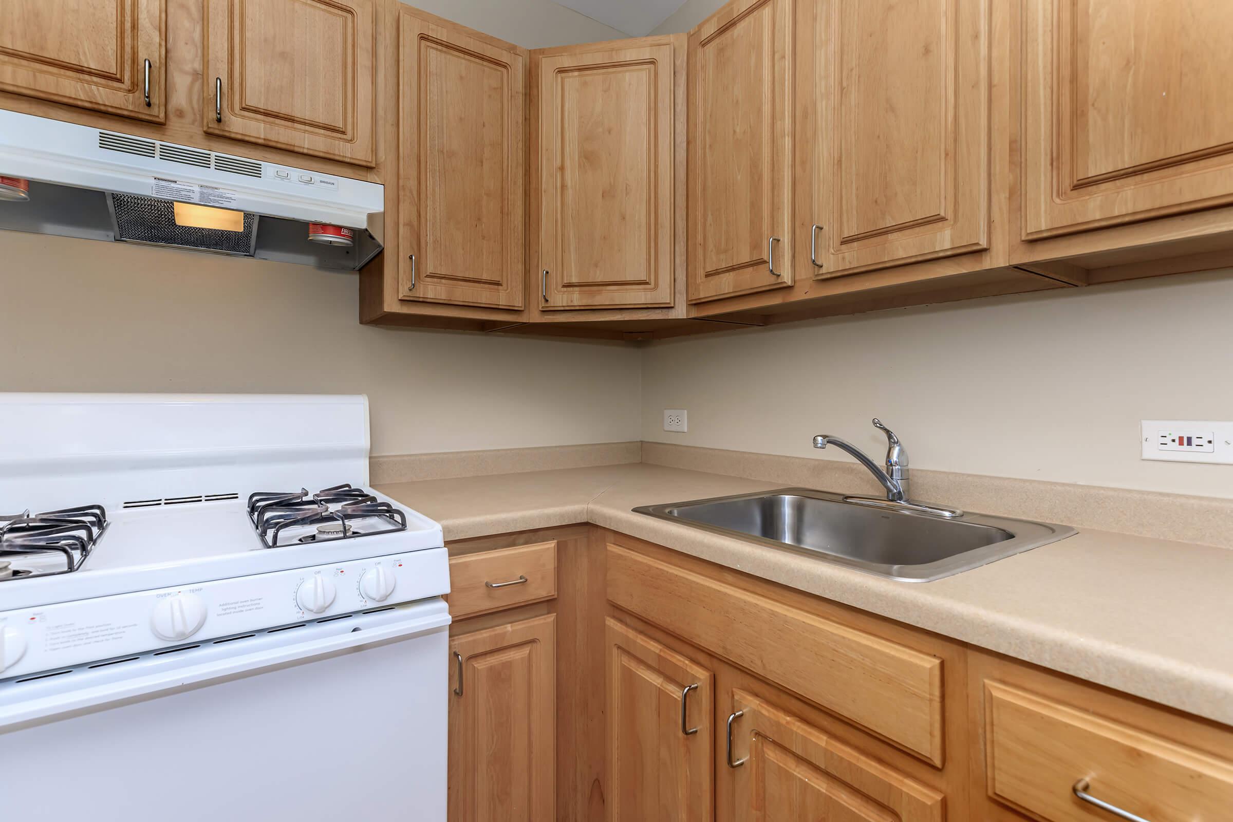 a kitchen with wooden cabinets and a sink