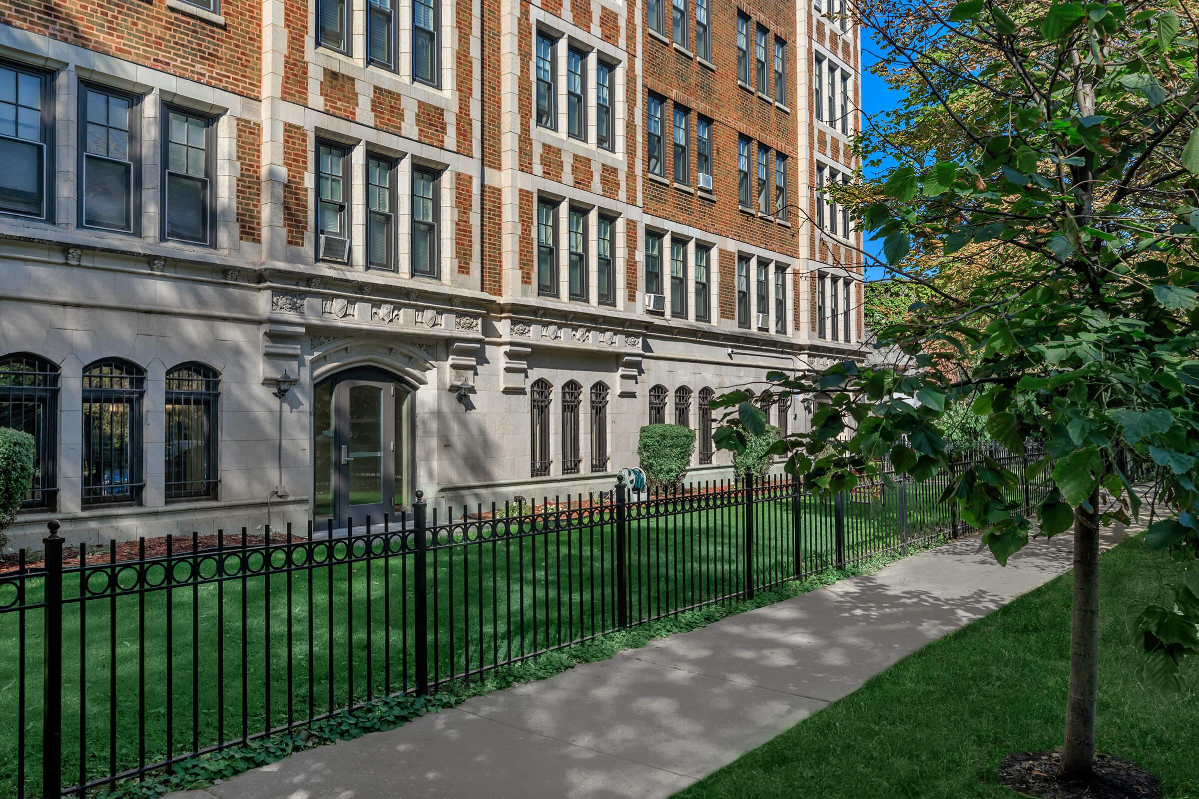 a close up of a green fence in front of a building