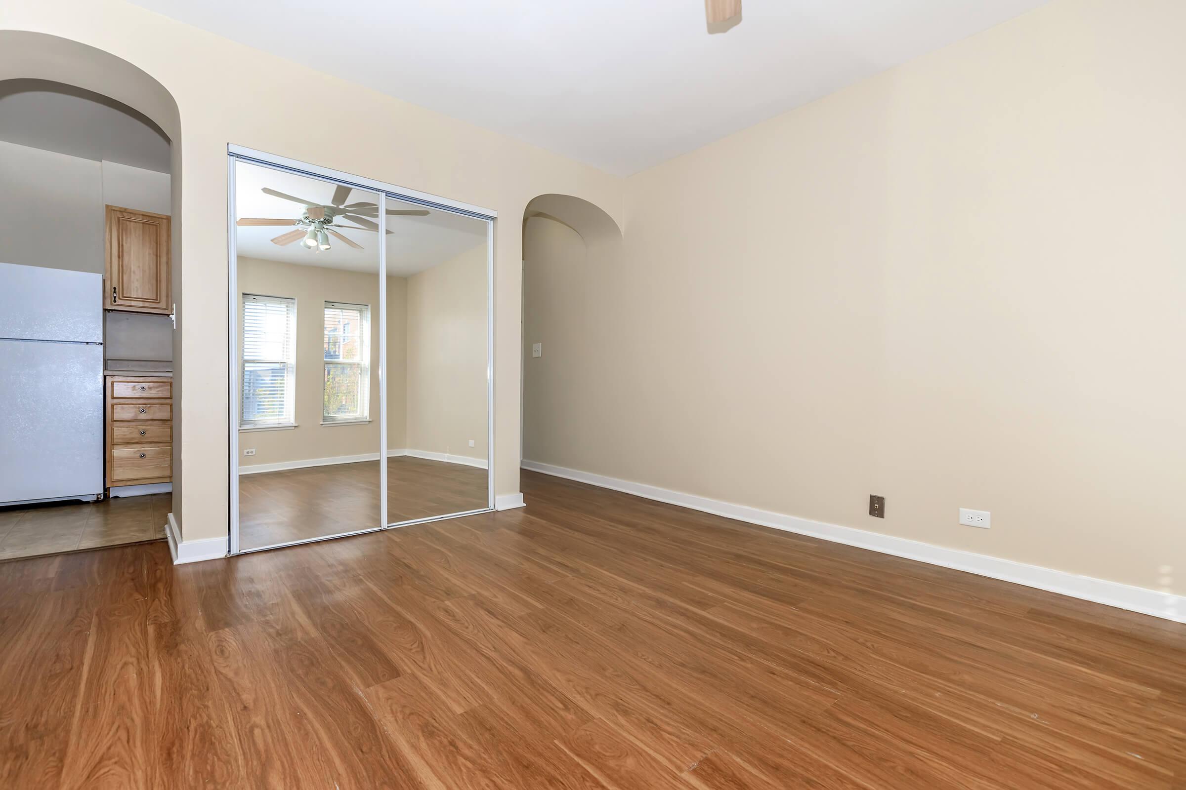 a large empty room with a wood floor