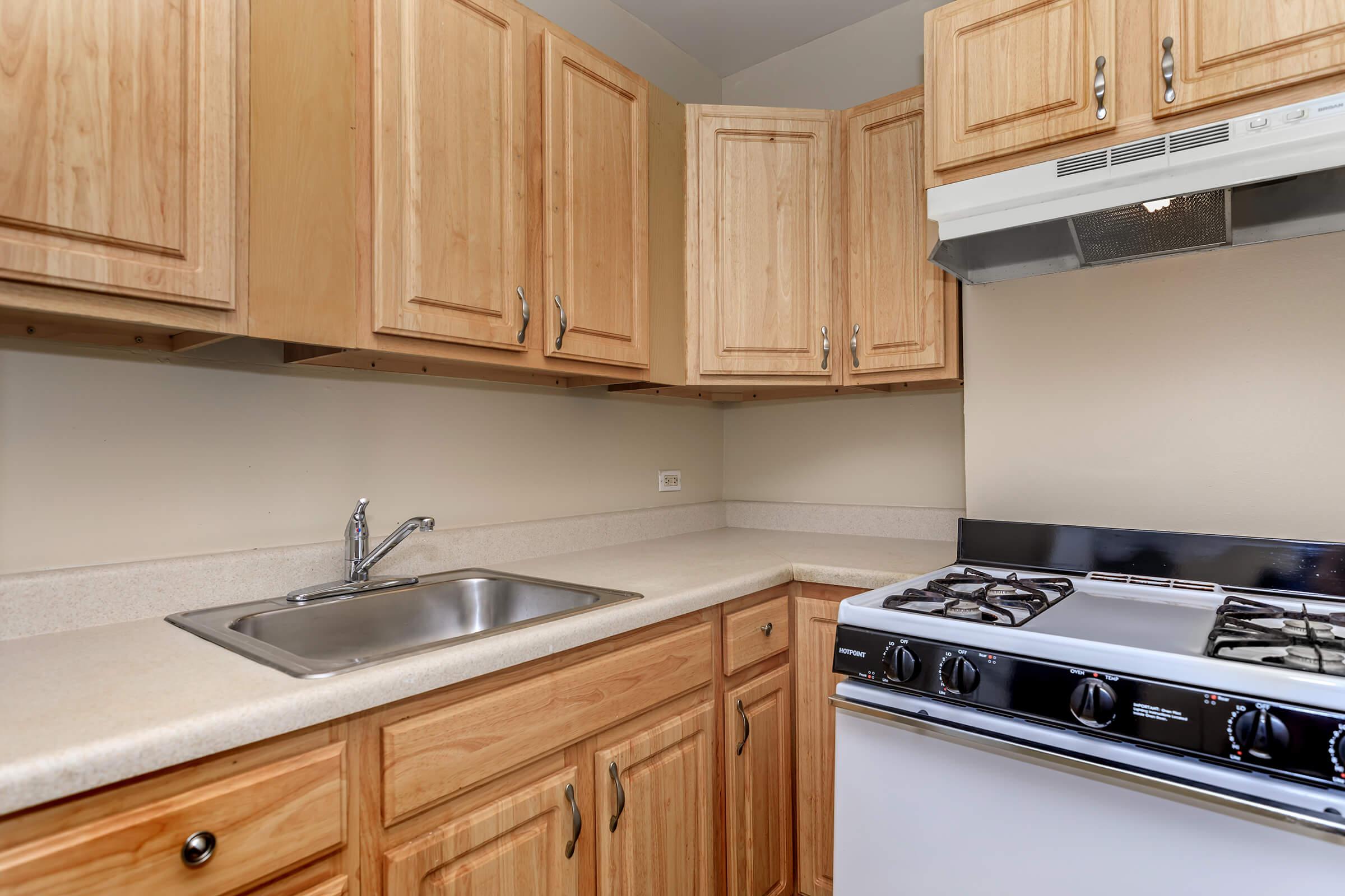 a kitchen with wooden cabinets and a microwave