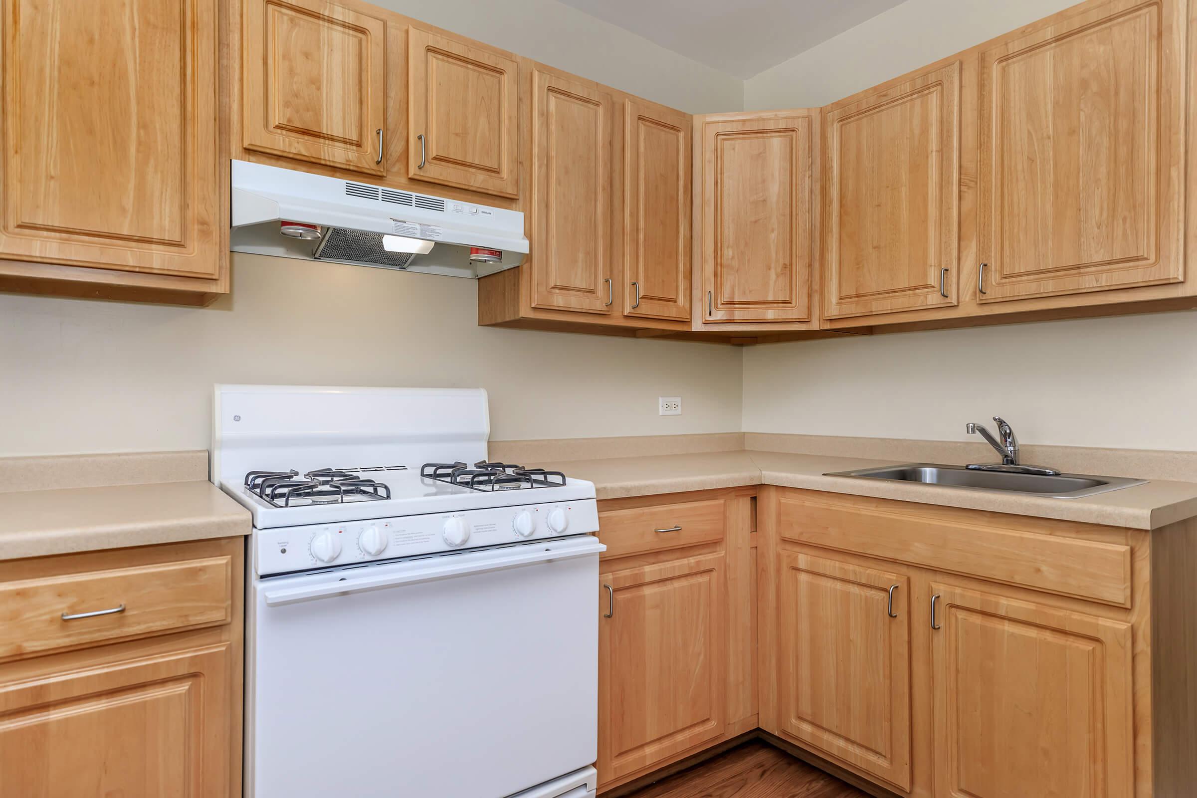 a kitchen with wooden cabinets and a microwave