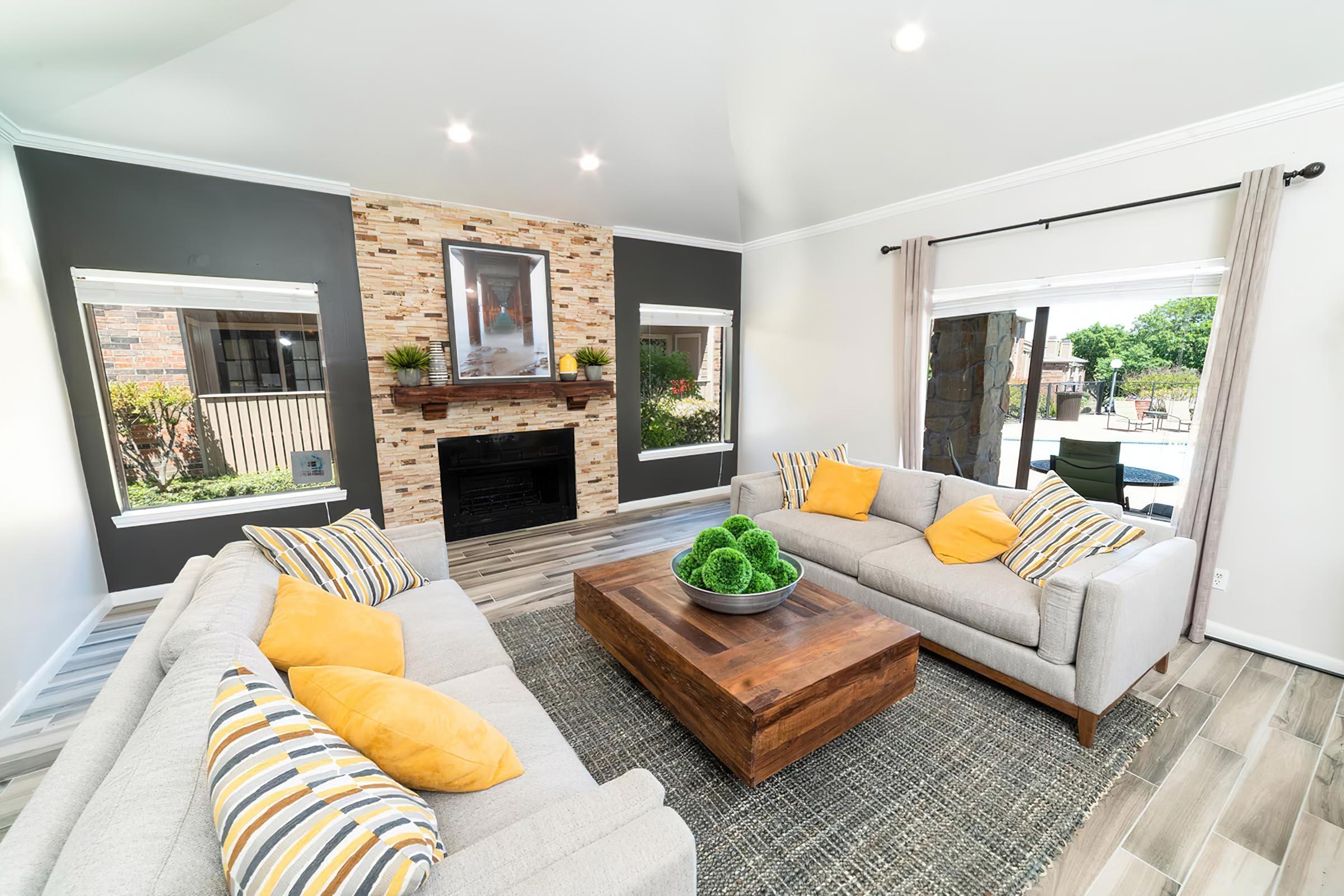 a living room filled with furniture and a fire place