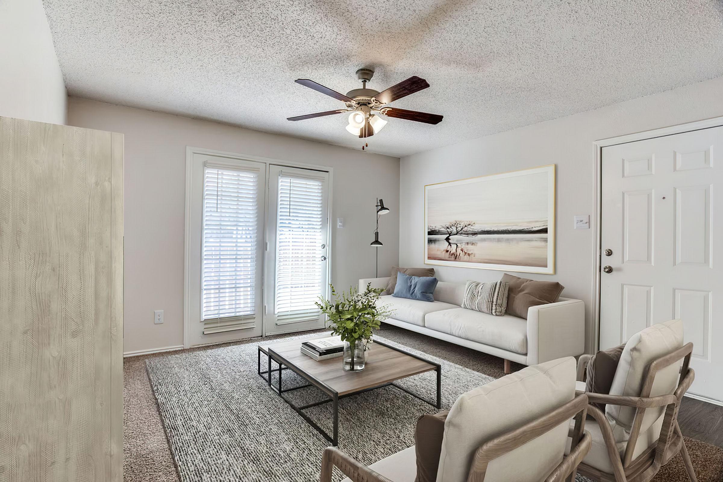 a living room filled with furniture and a large window