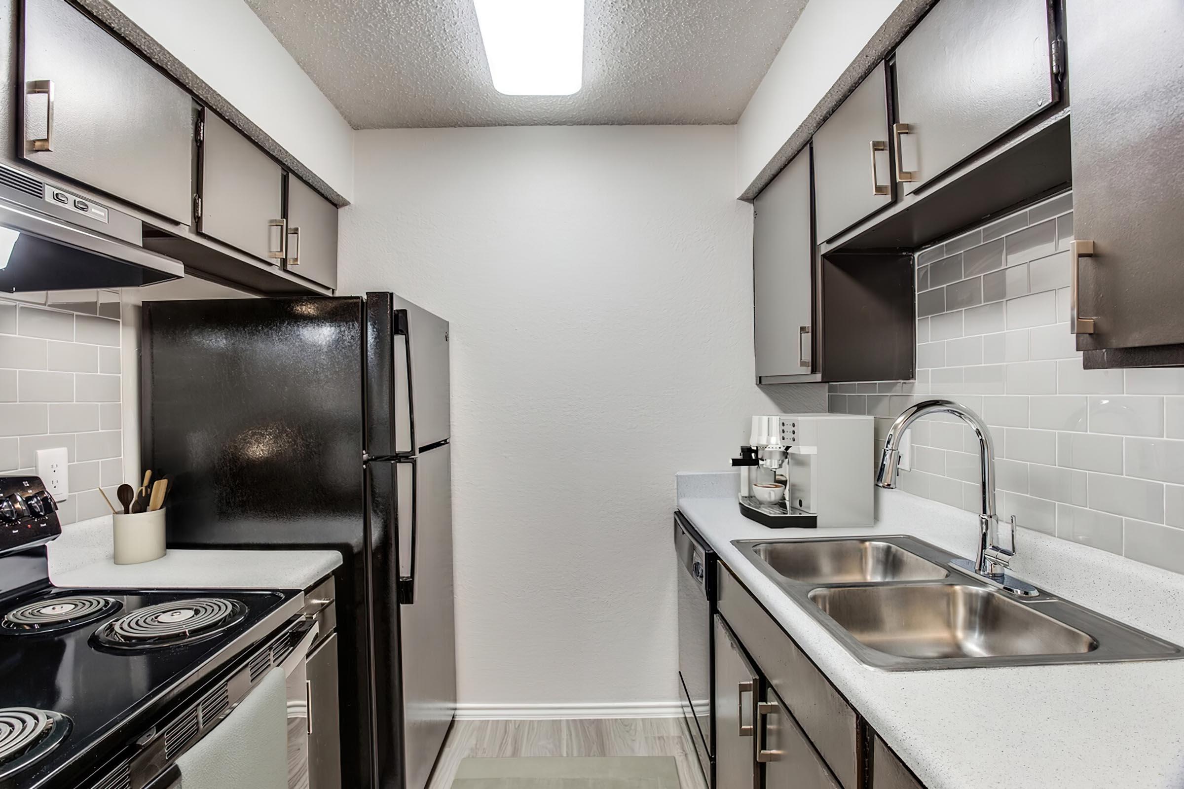 a kitchen with a stainless steel sink