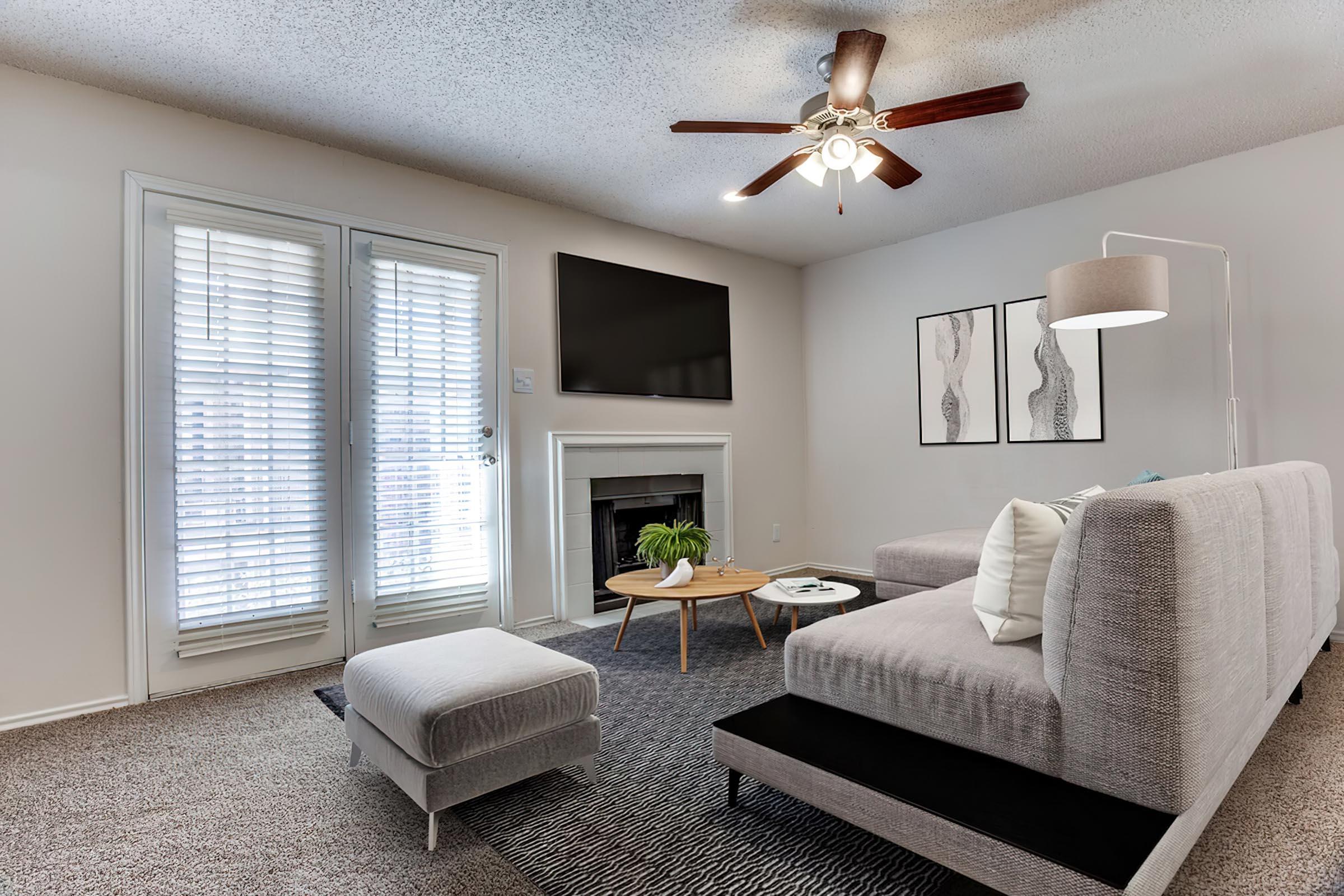 a living room filled with furniture and a large window