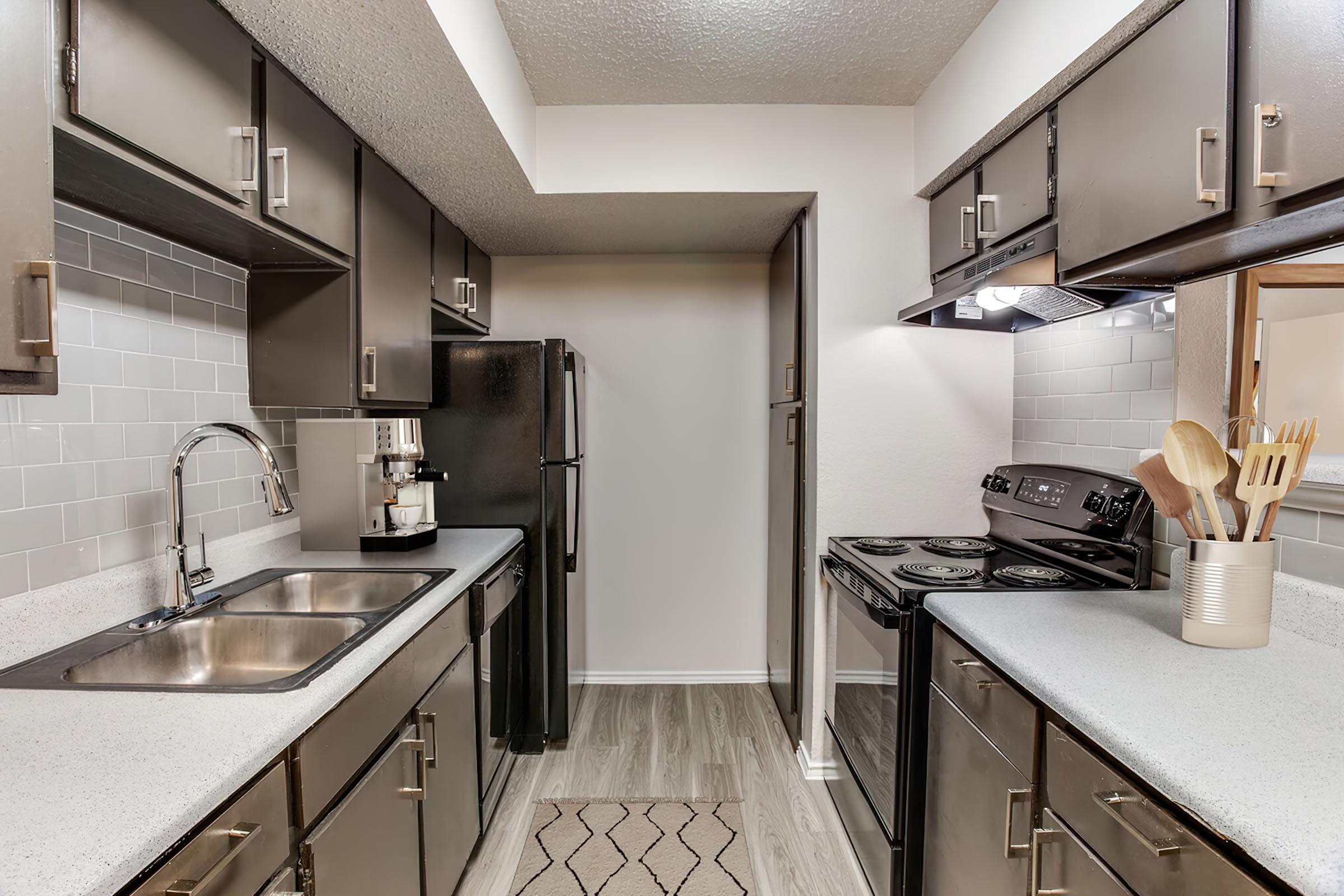 a kitchen with a sink and a mirror