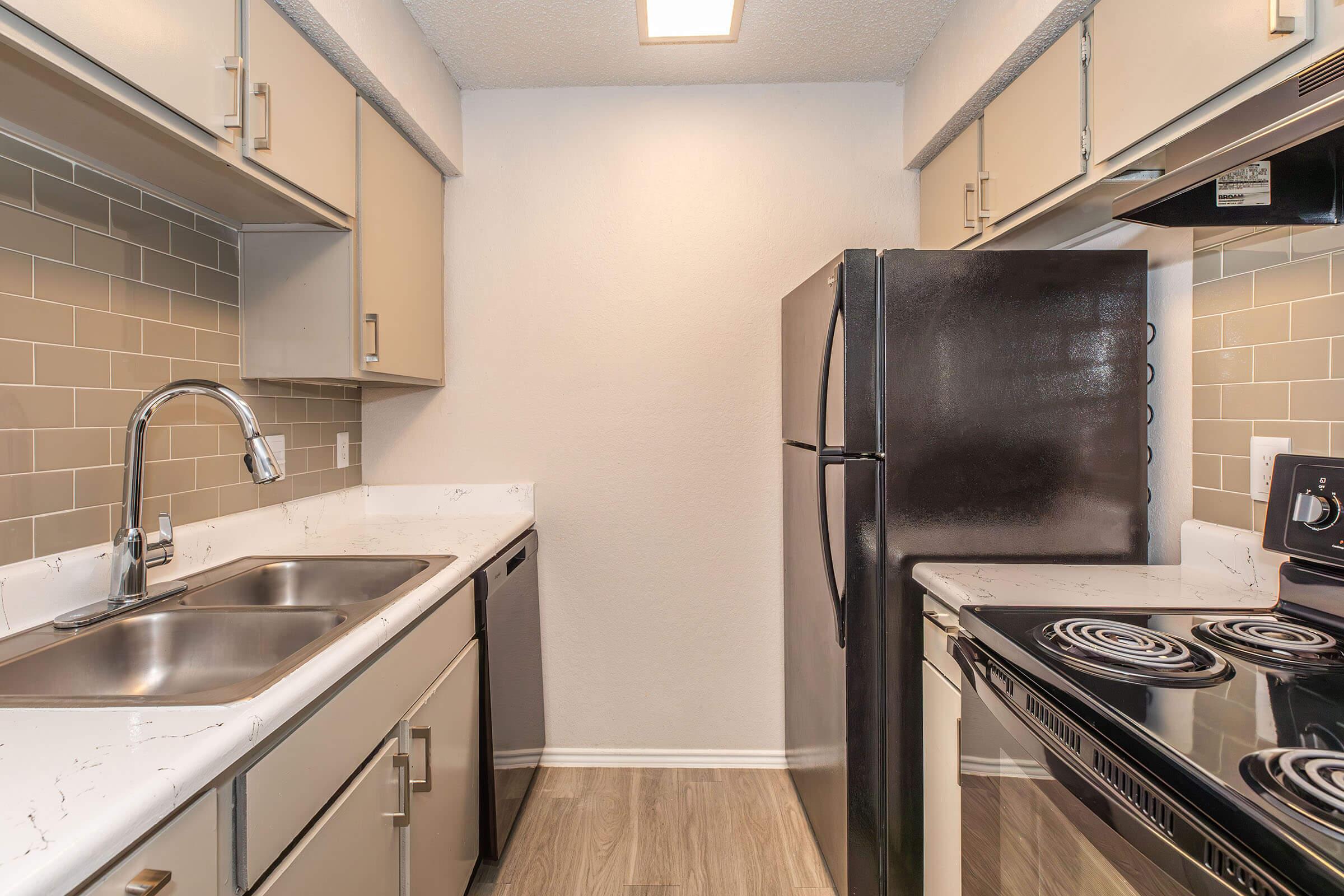 a stove top oven sitting inside of a kitchen