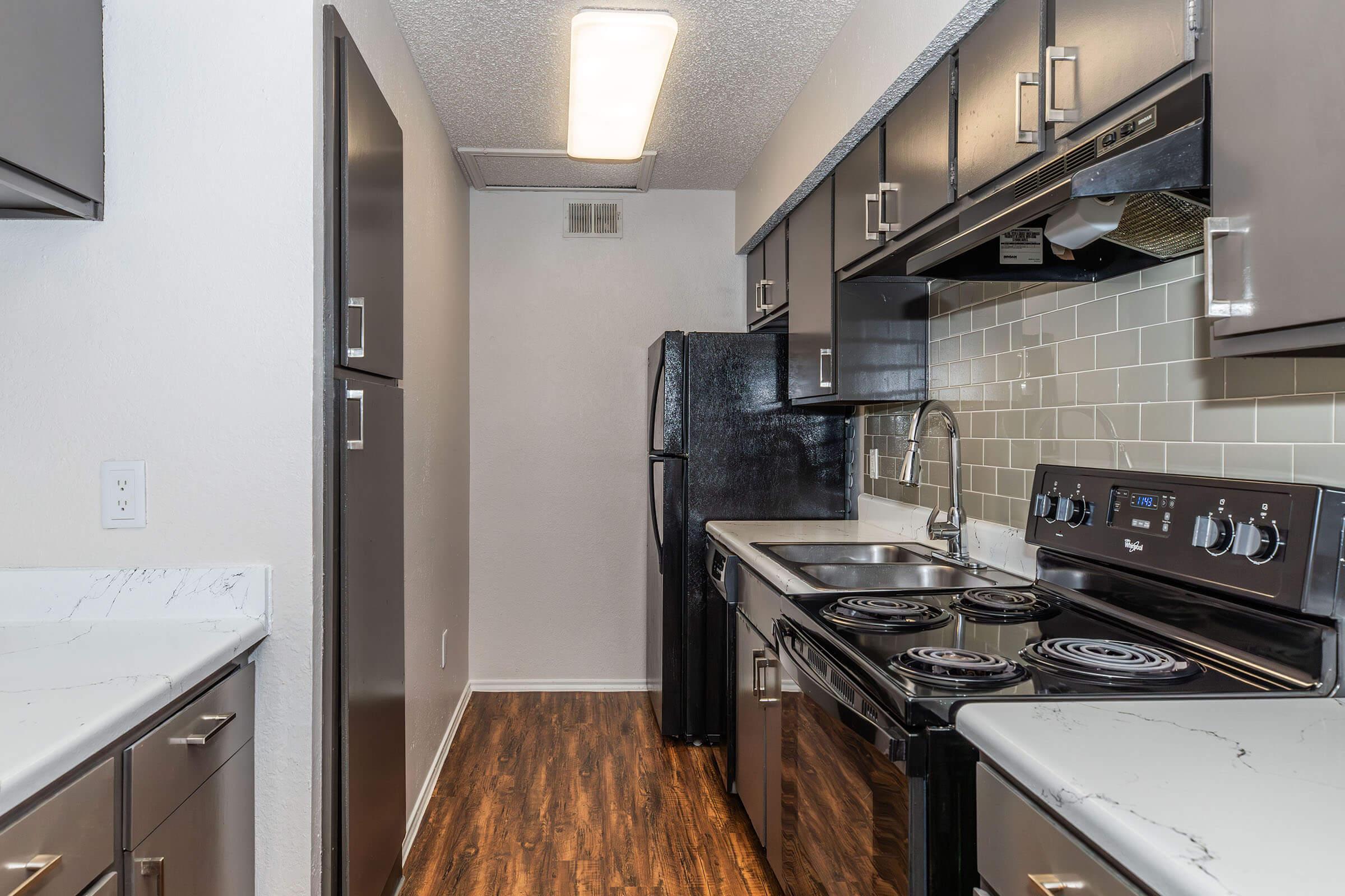 a kitchen with a stove and a sink