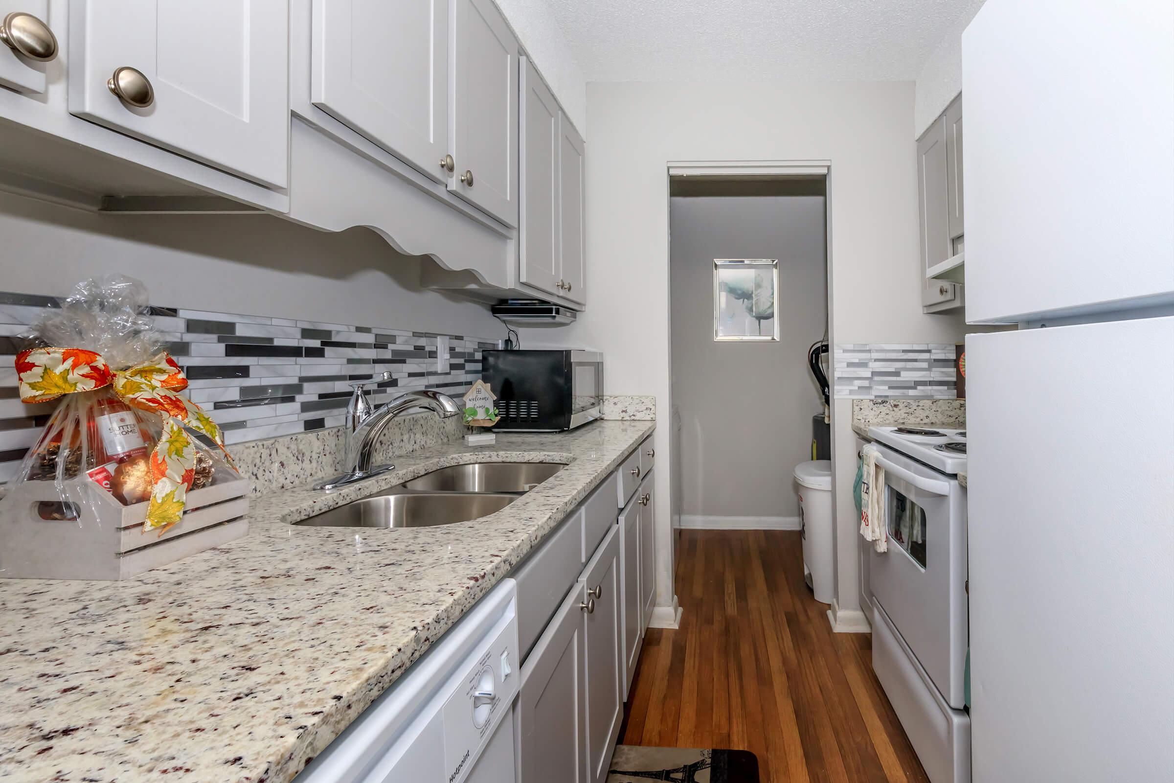 a kitchen with a sink and a refrigerator