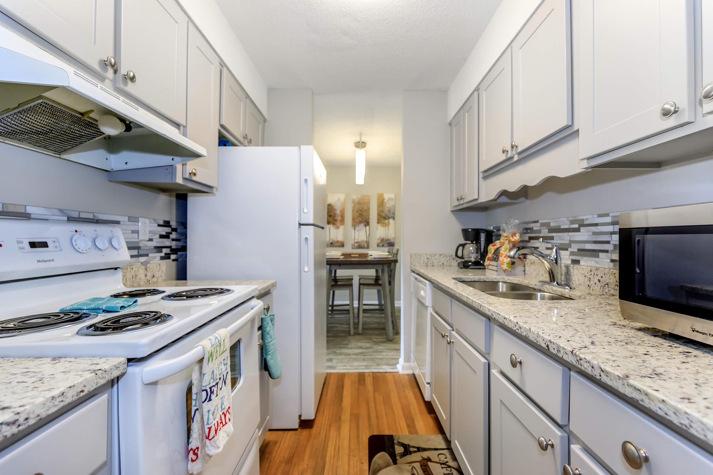 a kitchen with a stove sink and refrigerator