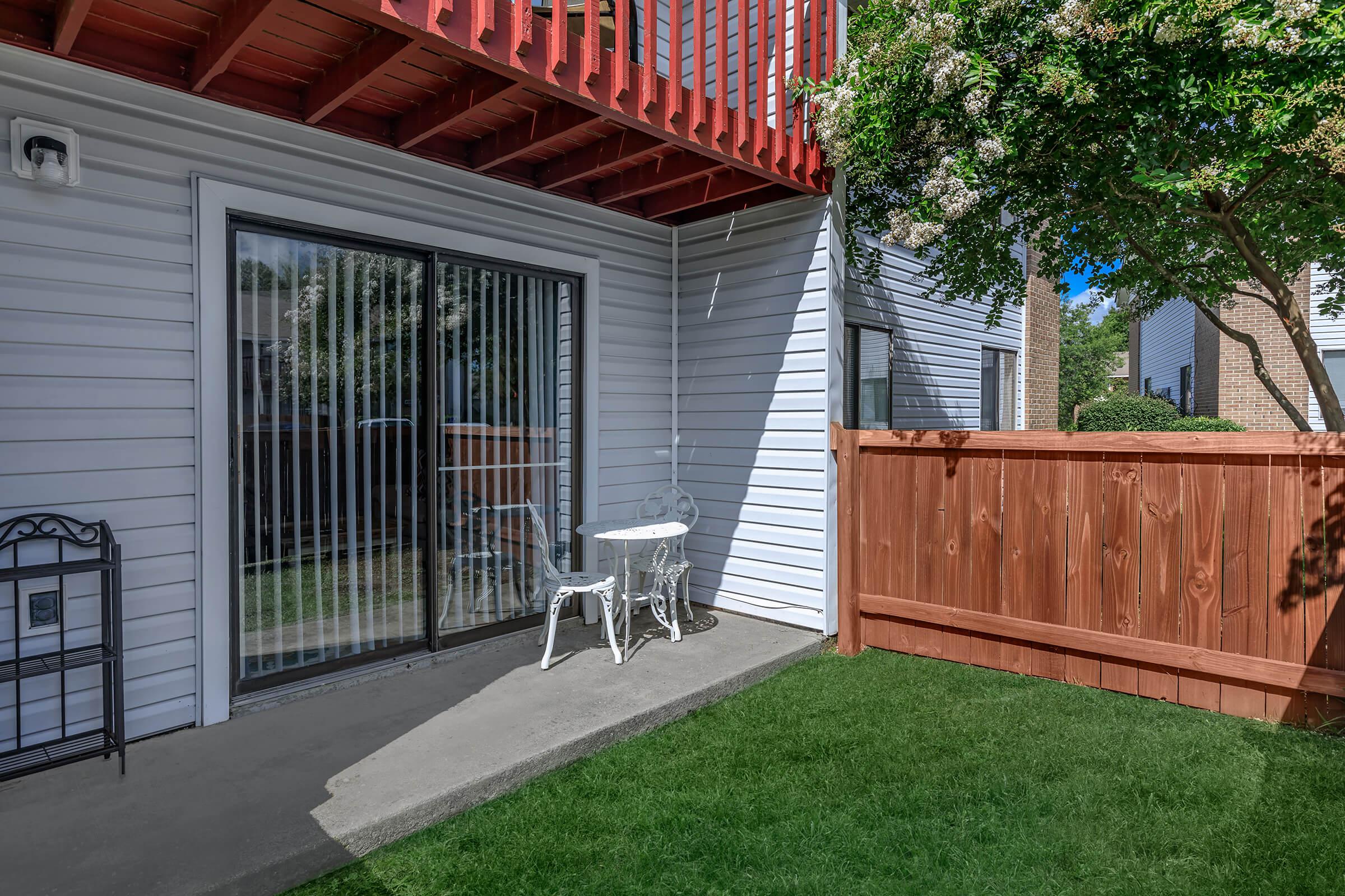 a house with a fence in front of a building