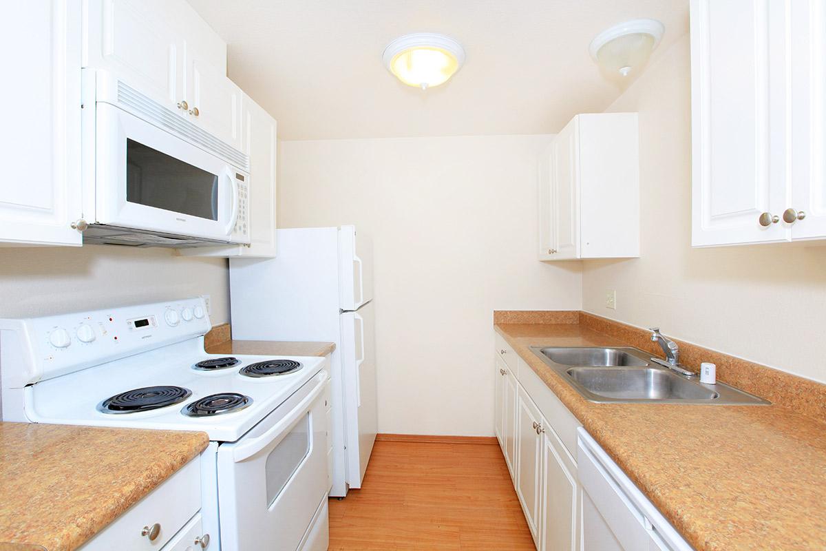 a white stove top oven sitting inside of a kitchen