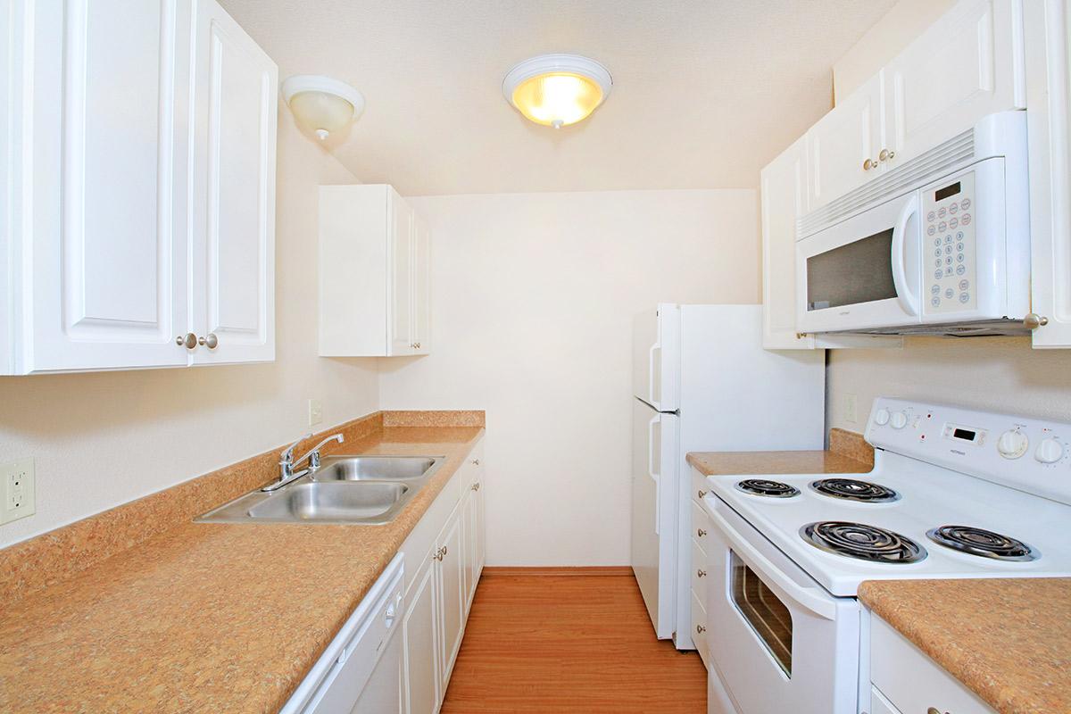 a white stove top oven sitting inside of a kitchen