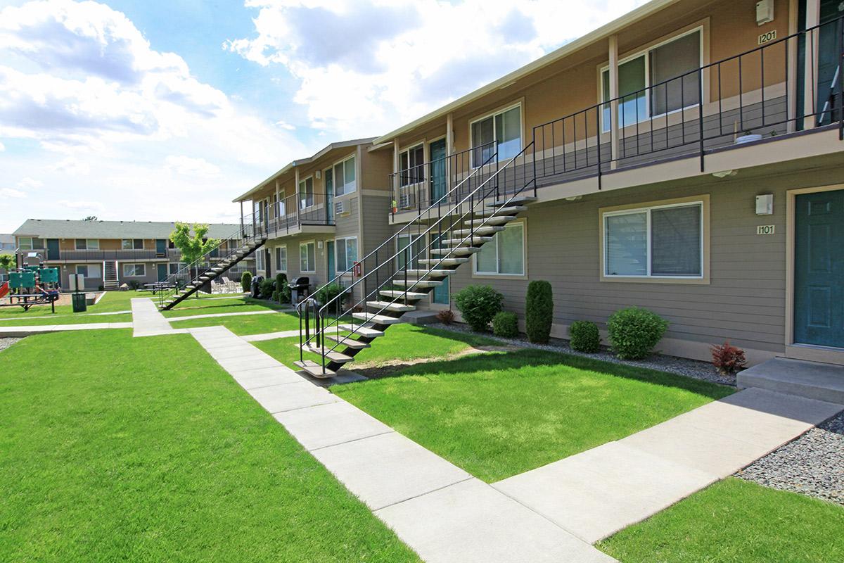 a house with a lawn in front of a building