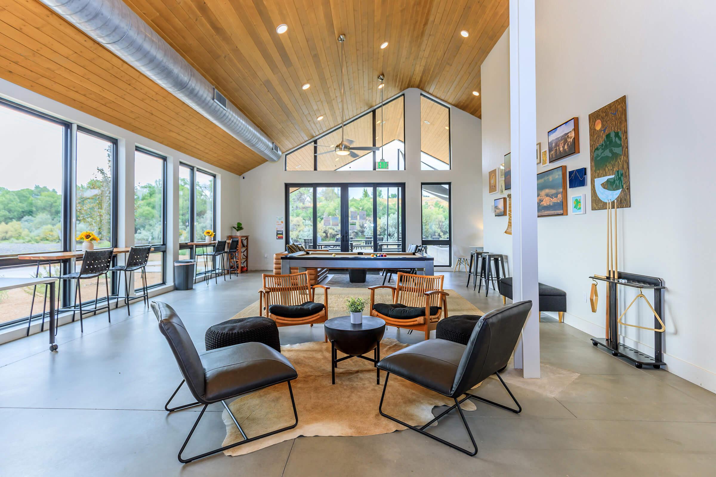 a living room filled with furniture and a large window