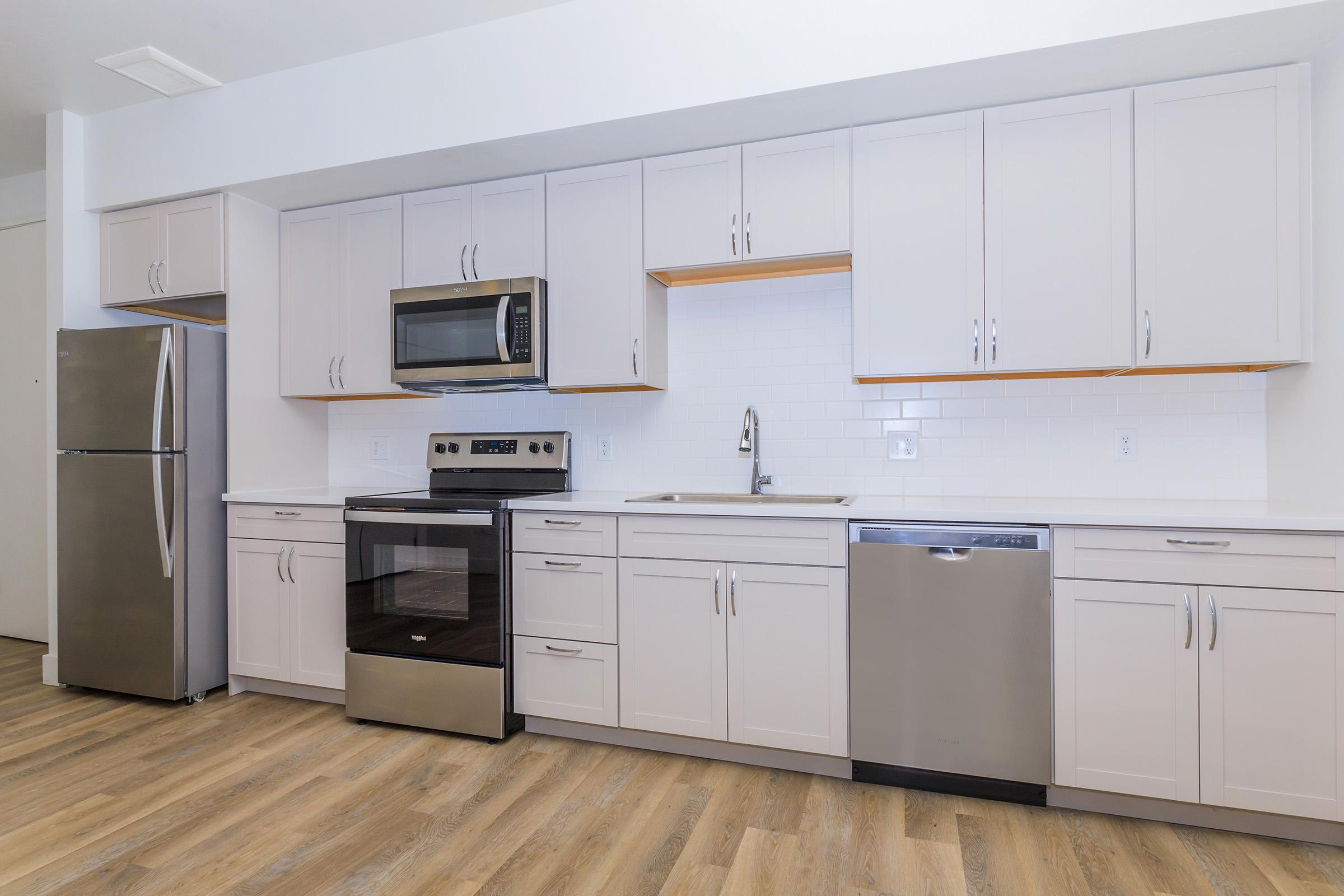 a large kitchen with stainless steel appliances