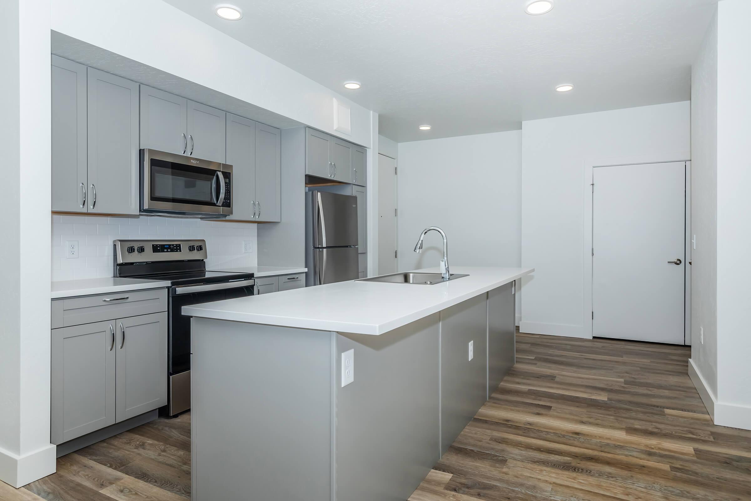 a kitchen with a sink and a refrigerator