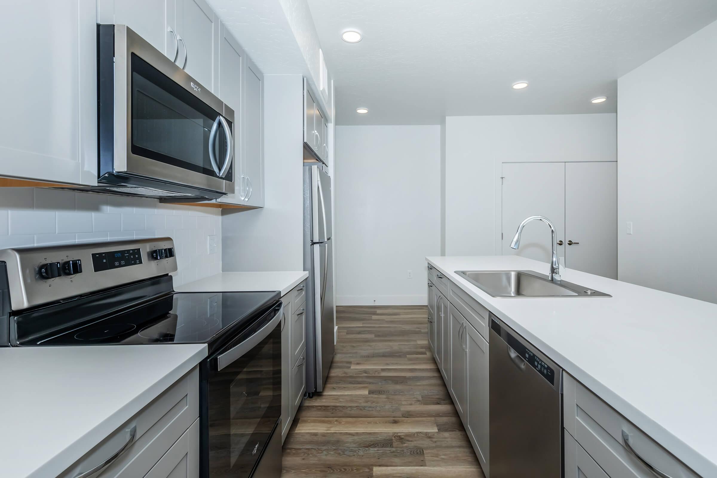 a kitchen with a stove a sink and a microwave