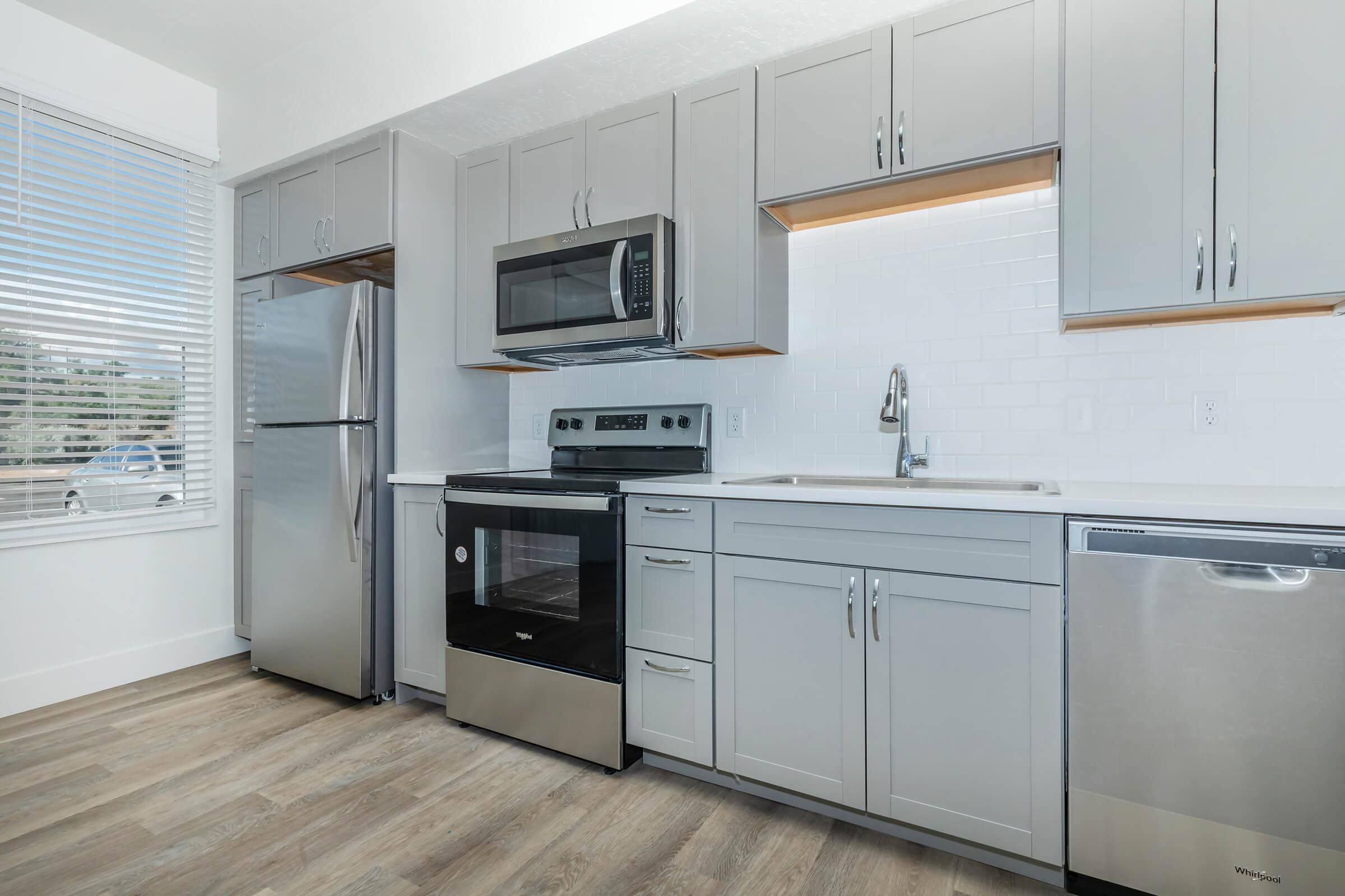 a kitchen with a stove and a refrigerator