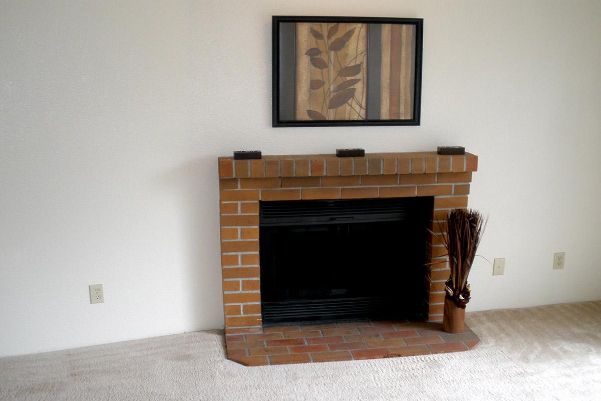 a fire place sitting in a living room with a fireplace