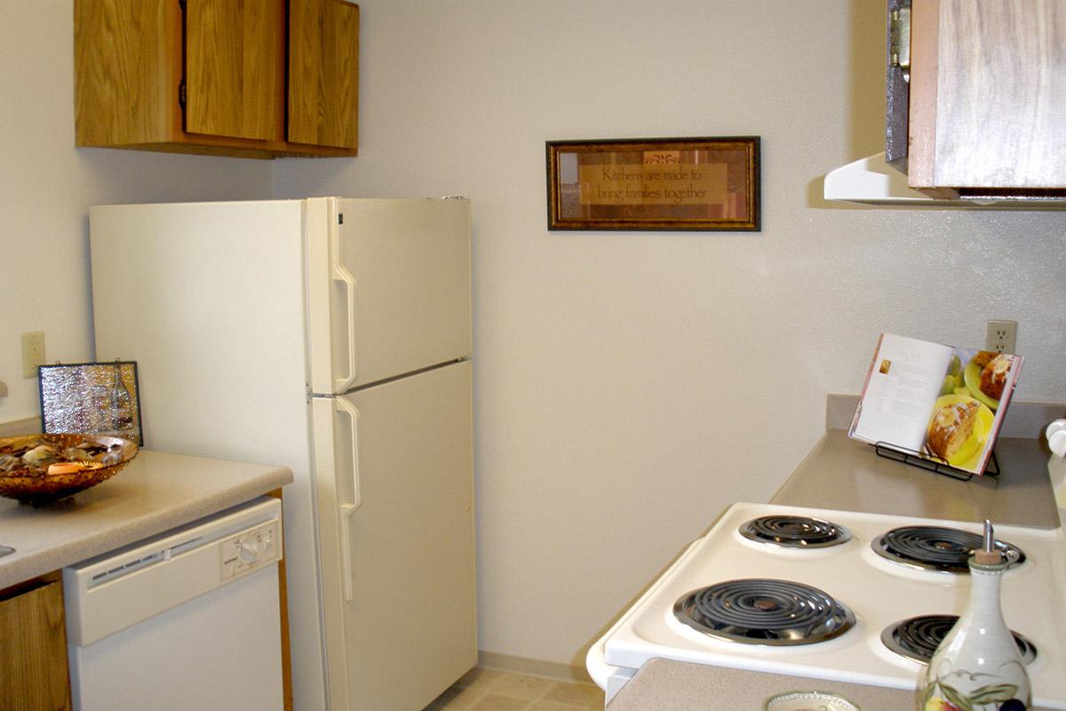a kitchen with a stove top oven sitting inside of a refrigerator