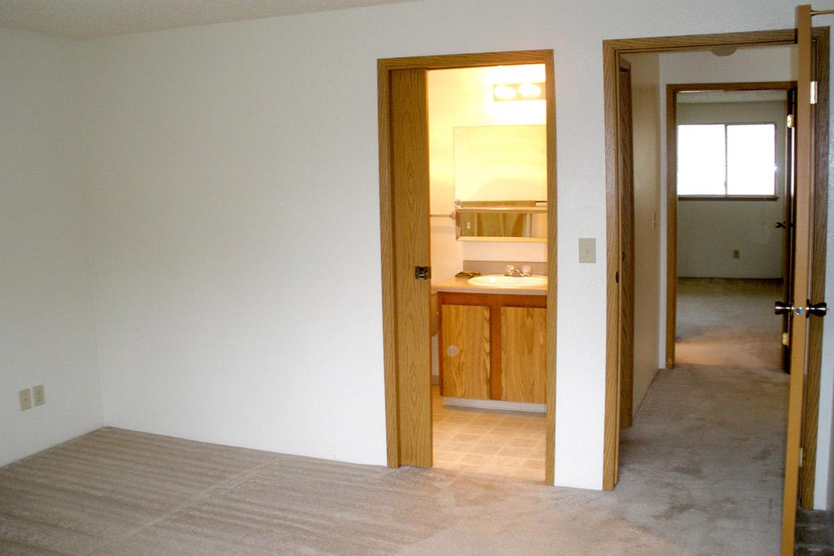 a bedroom with a wooden floor