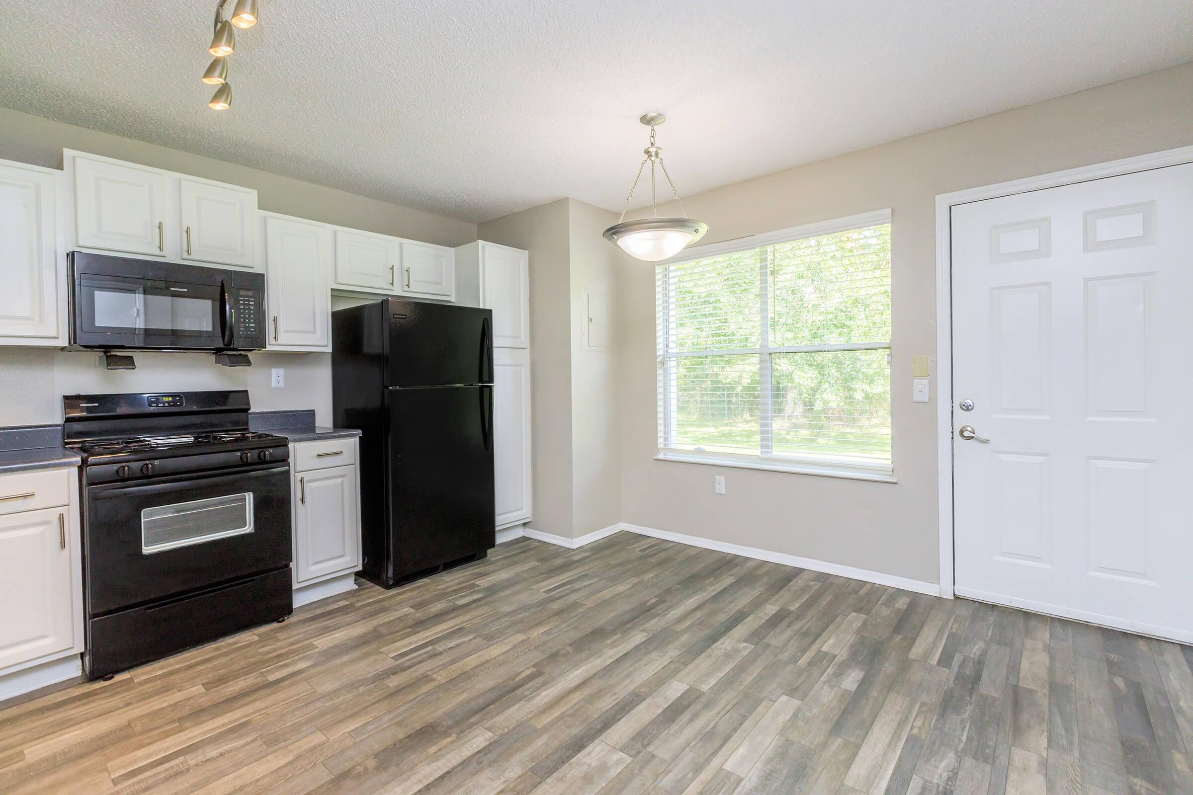 a kitchen with a wood floor