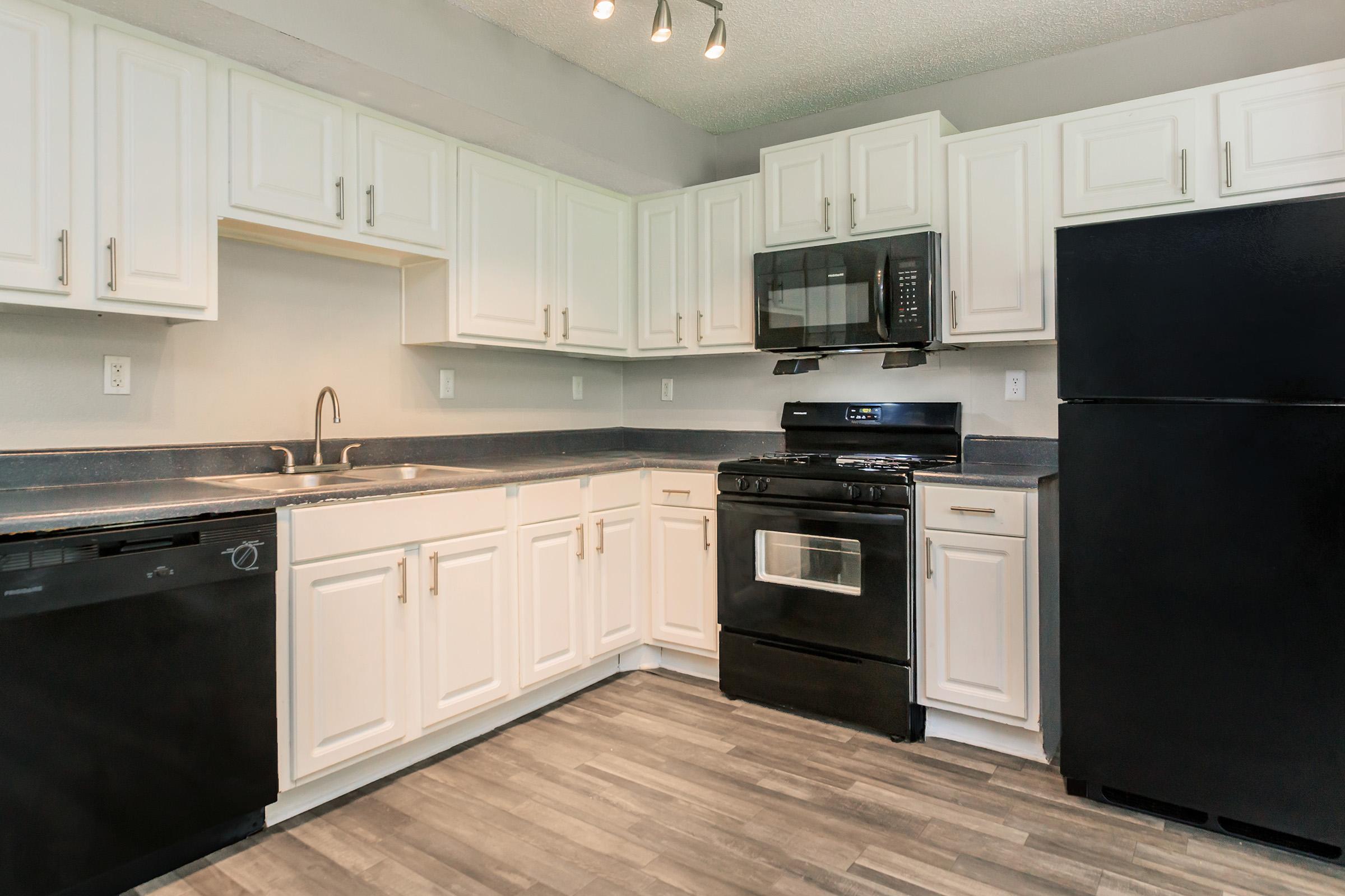 a large kitchen with stainless steel appliances