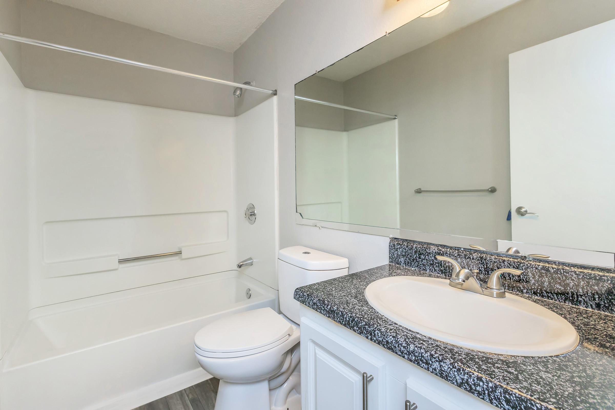 a kitchen with a sink and a mirror