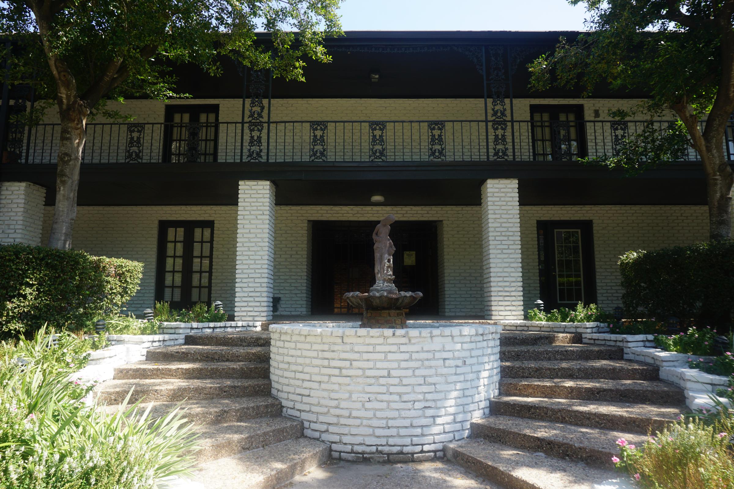 a stone statue in front of a house