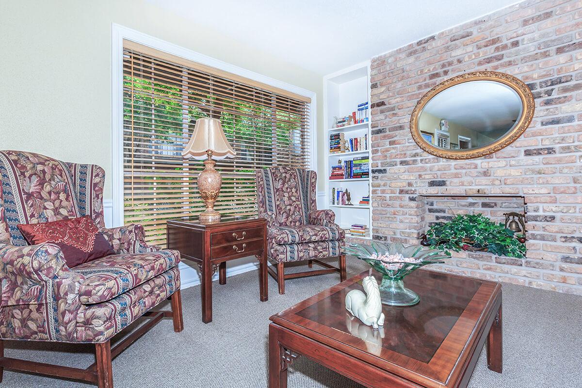 a living room filled with furniture and a fire place