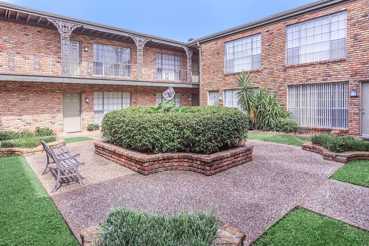 a large lawn in front of a brick building