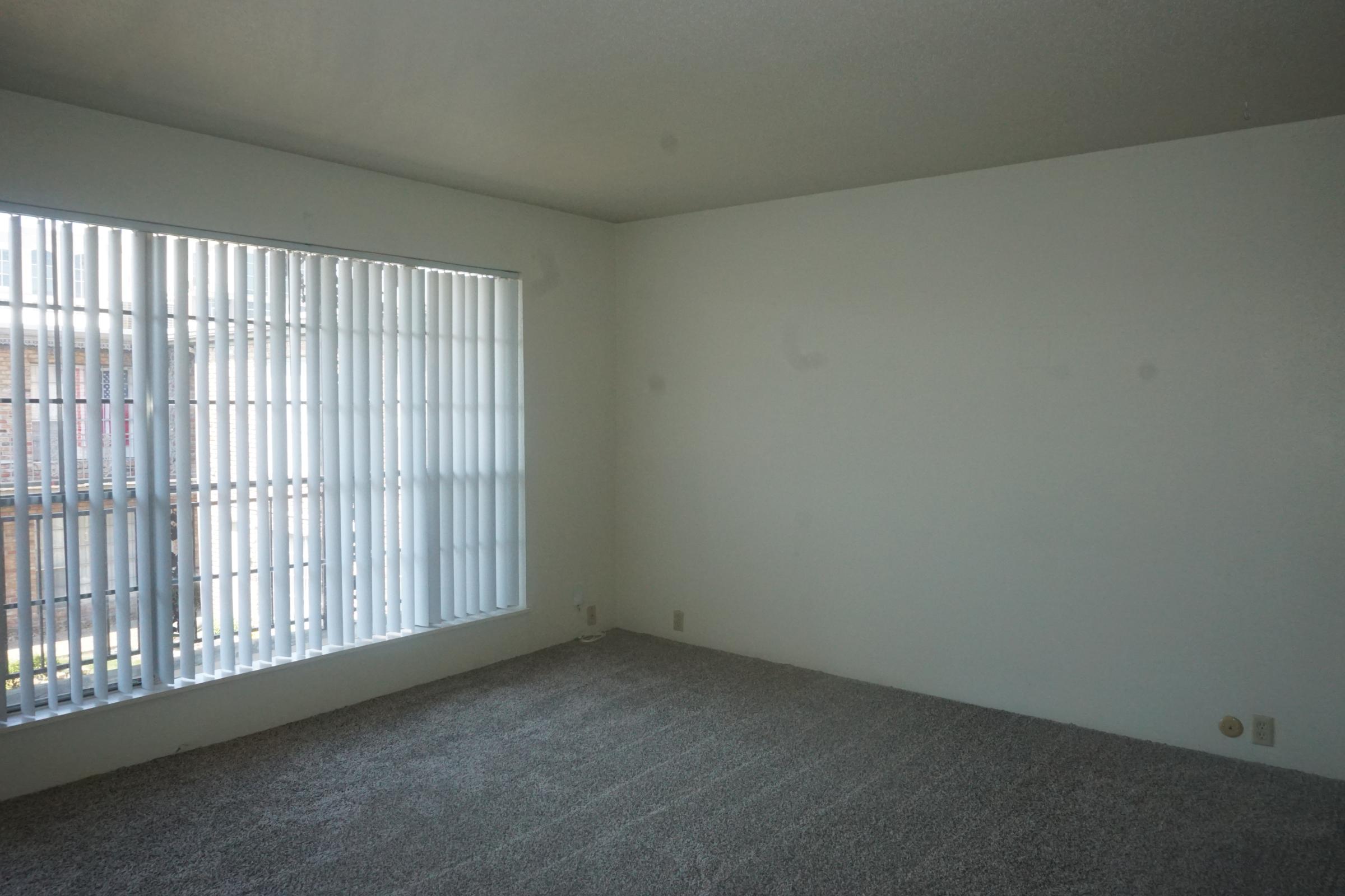 a bedroom with a large window