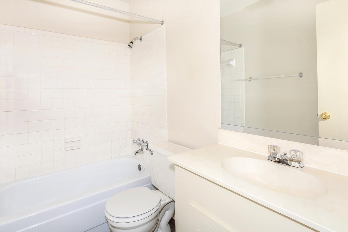 a white tub sitting next to a shower