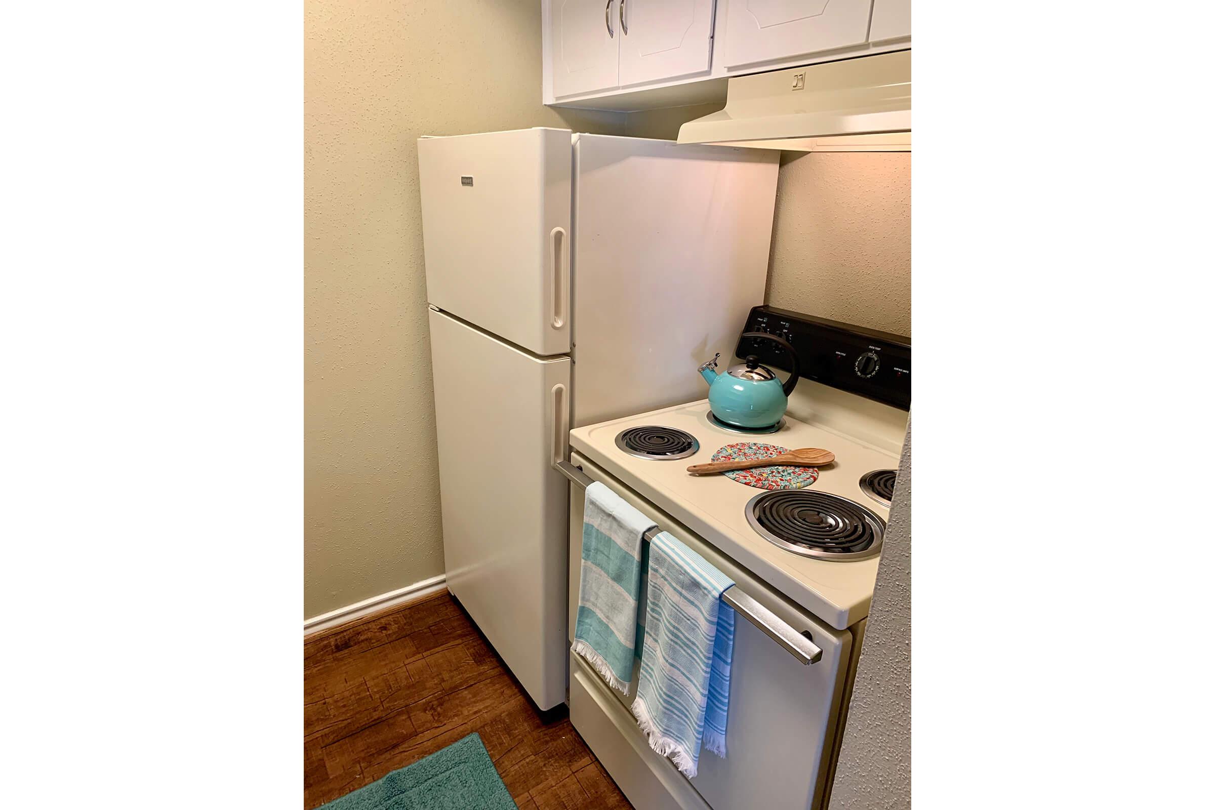 a white refrigerator freezer sitting inside of a kitchen