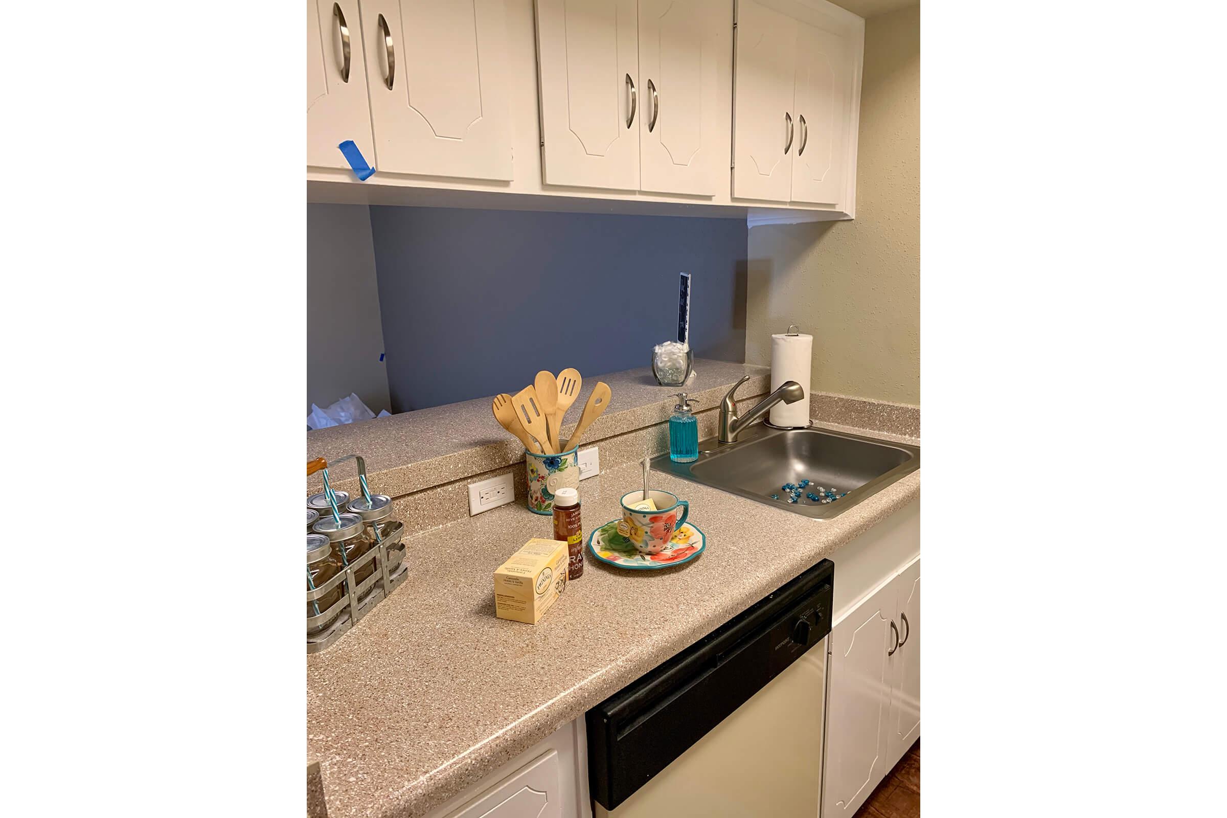 a kitchen with a sink and a mirror