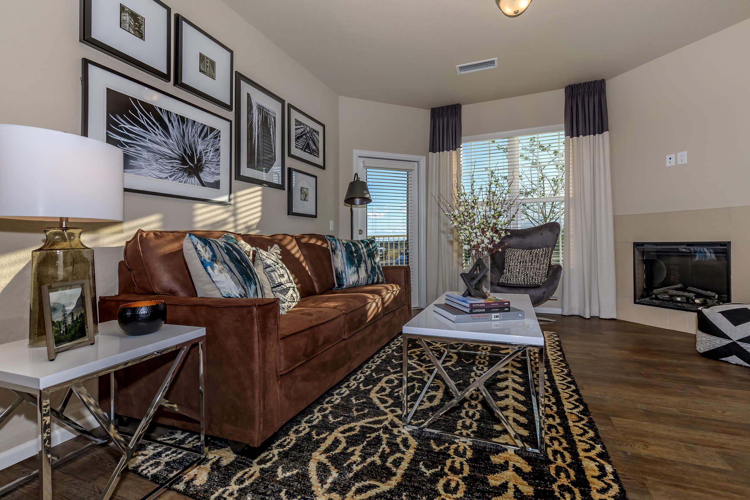 a living room filled with furniture and a large window