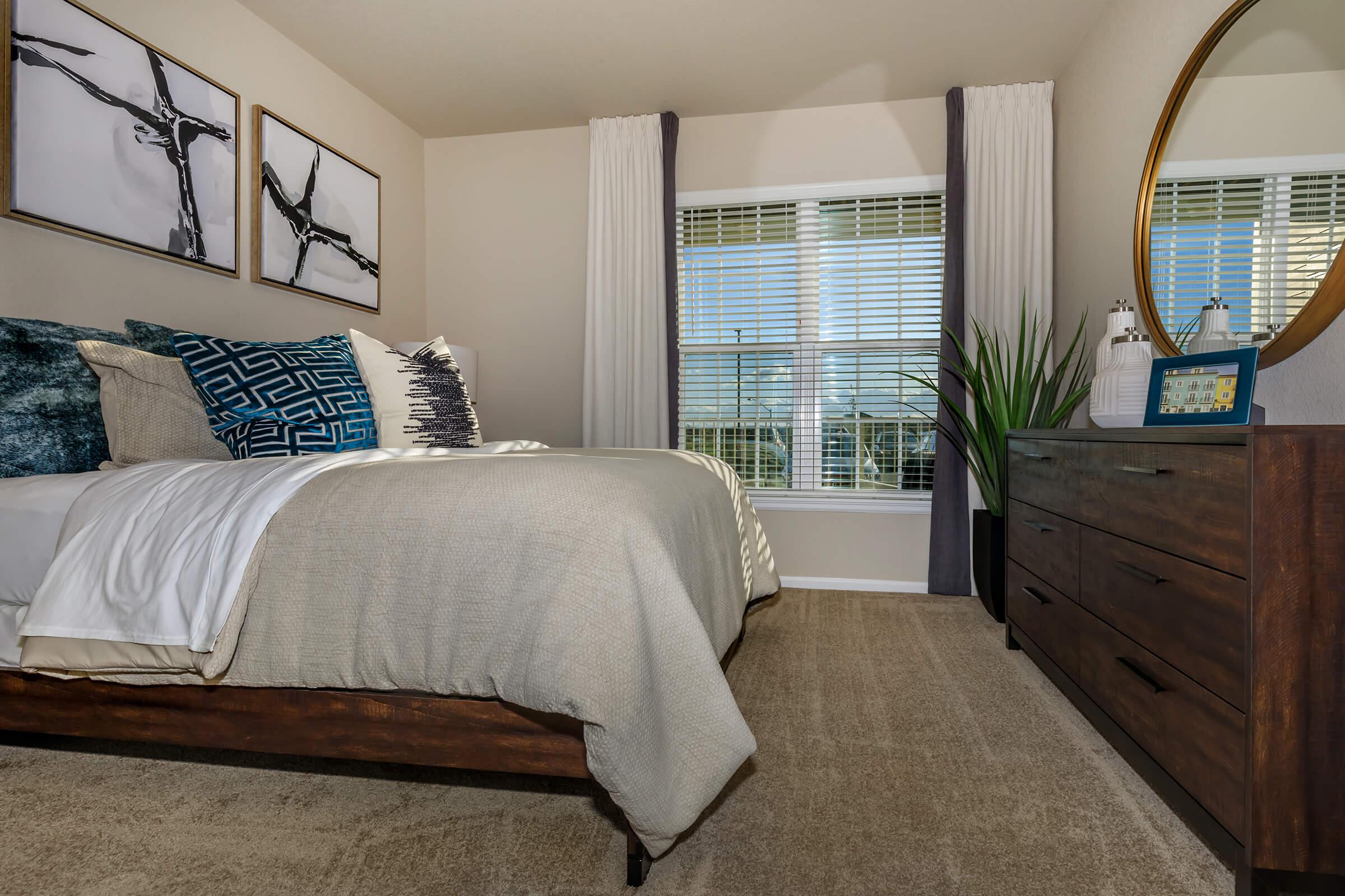 a bedroom with a bed and window in a room