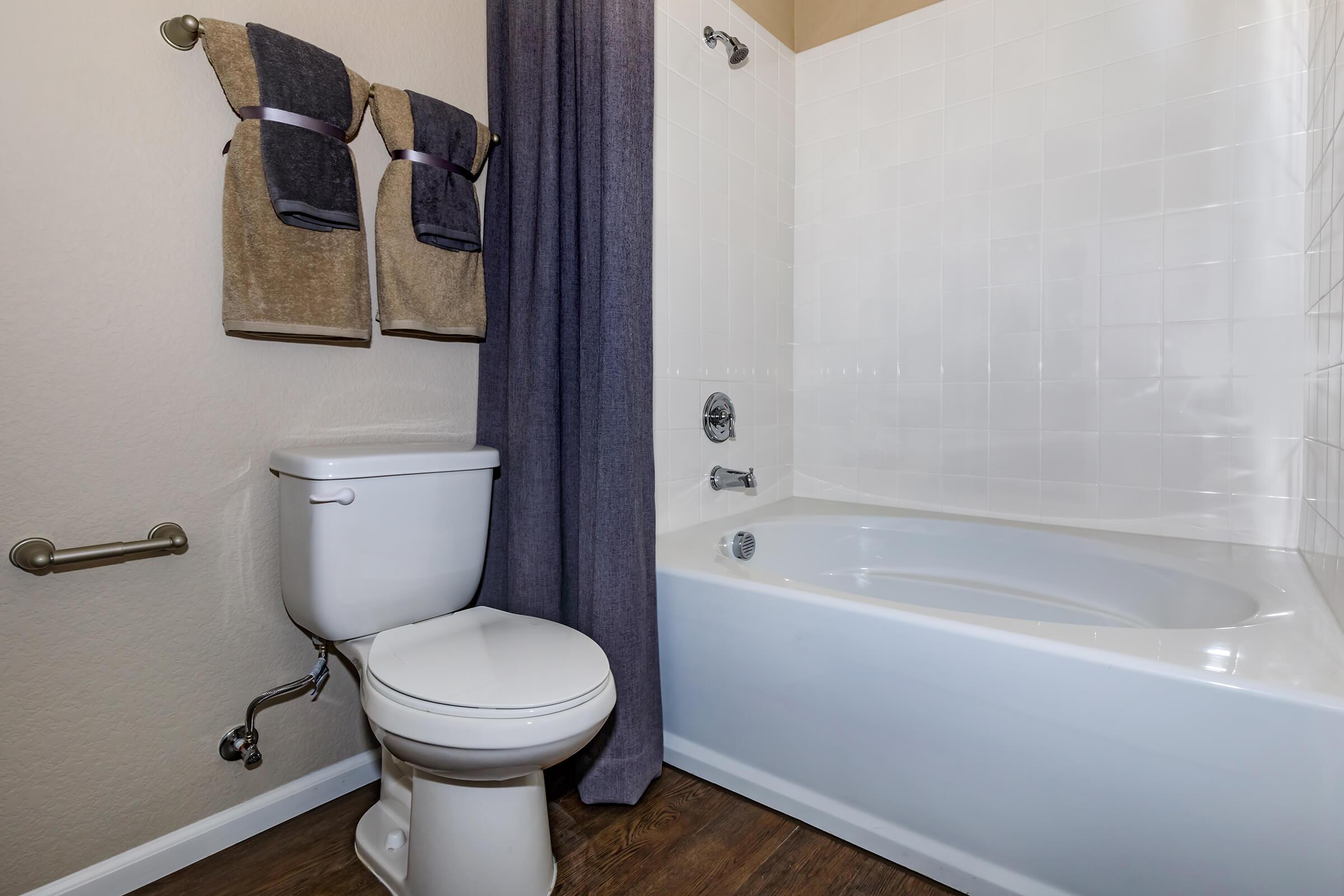 a white tub sitting next to a shower