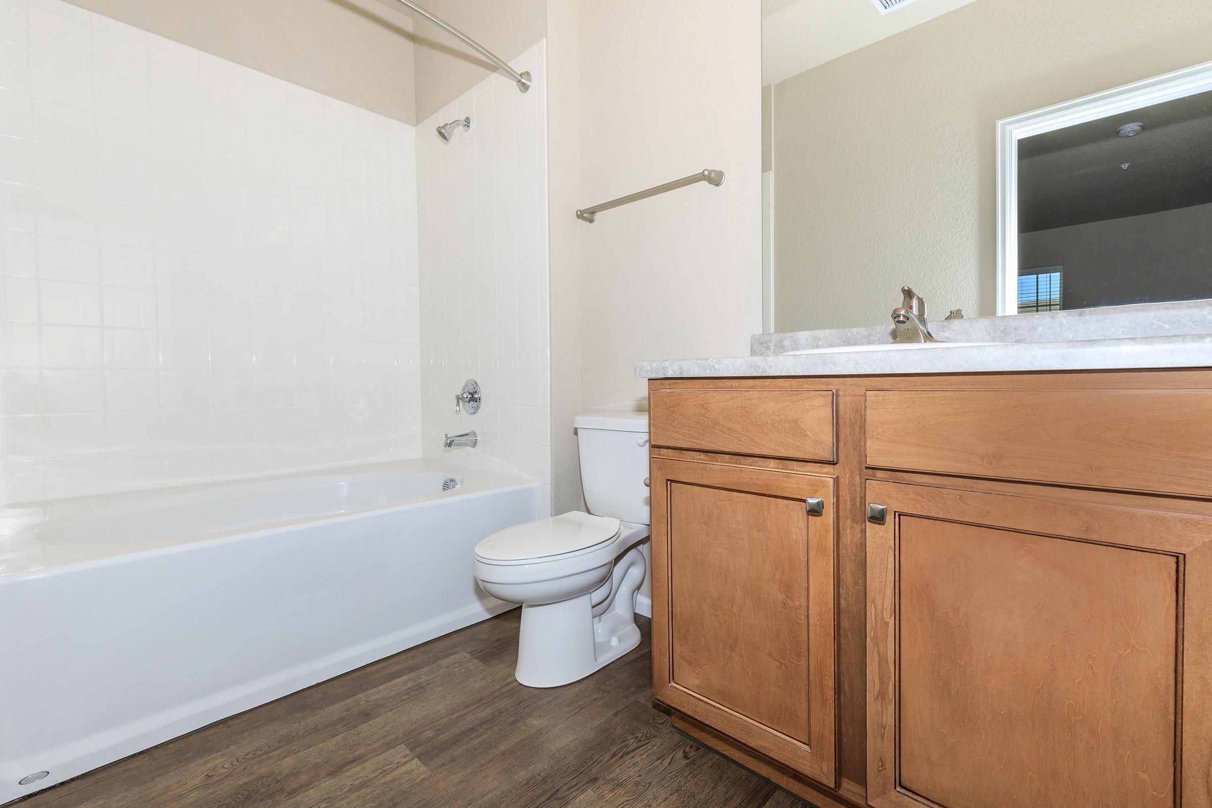 a large white tub sitting next to a sink