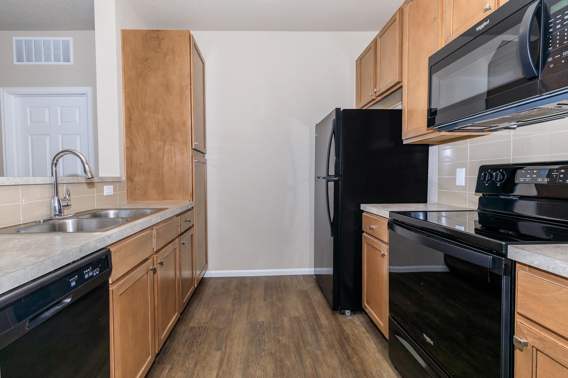 a kitchen with stainless steel appliances and wooden cabinets