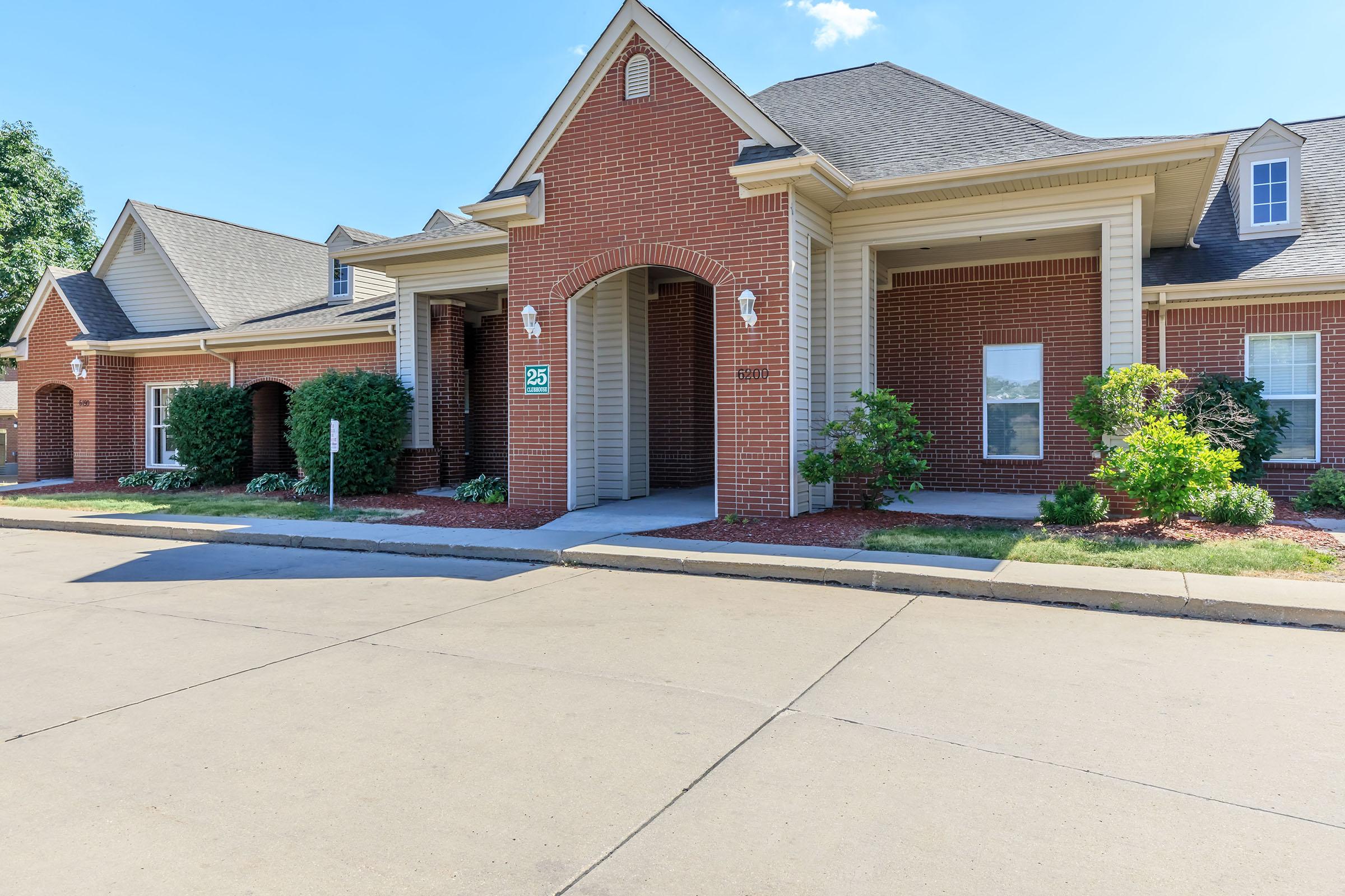 a house in front of a brick building