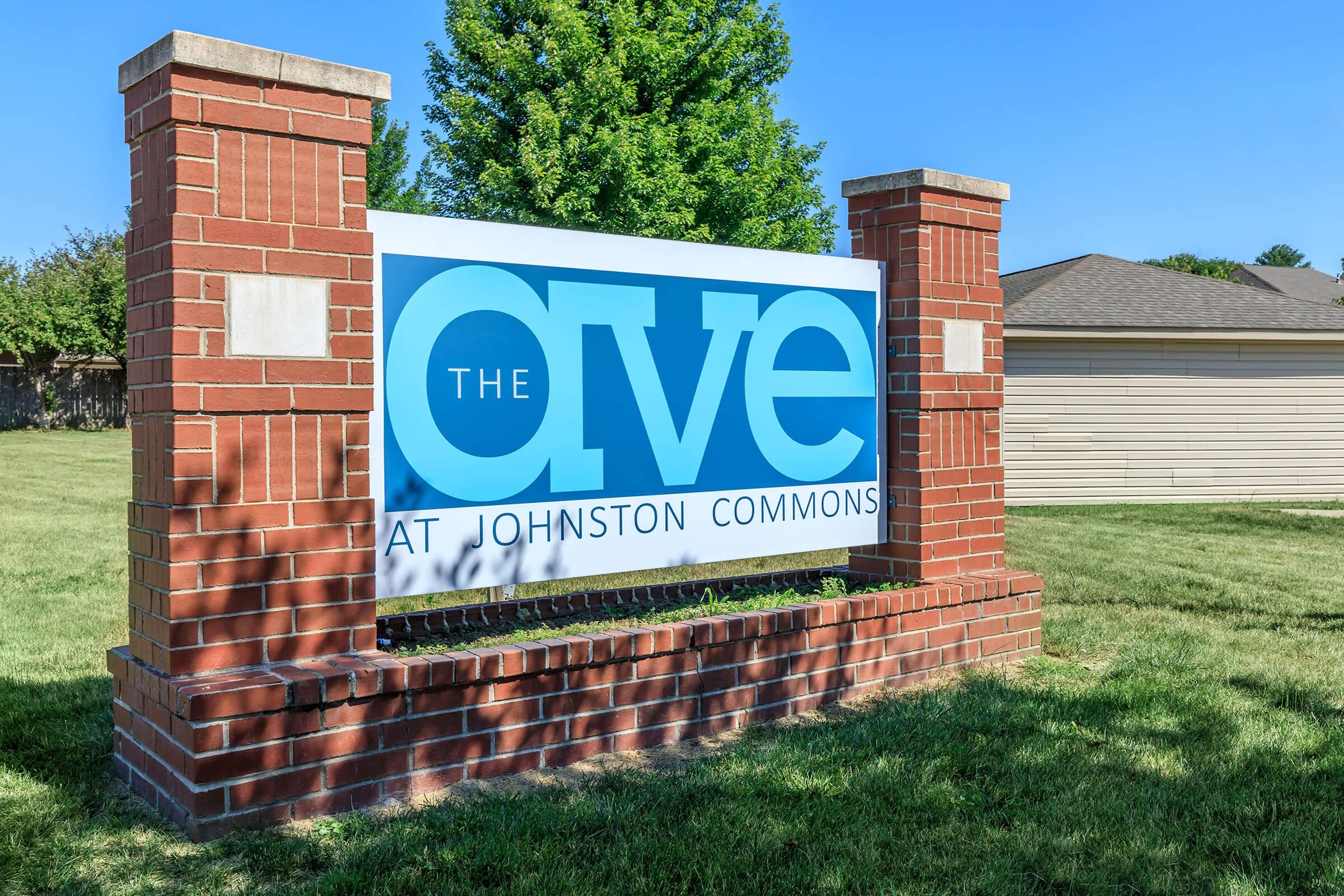 a sign in front of a brick building